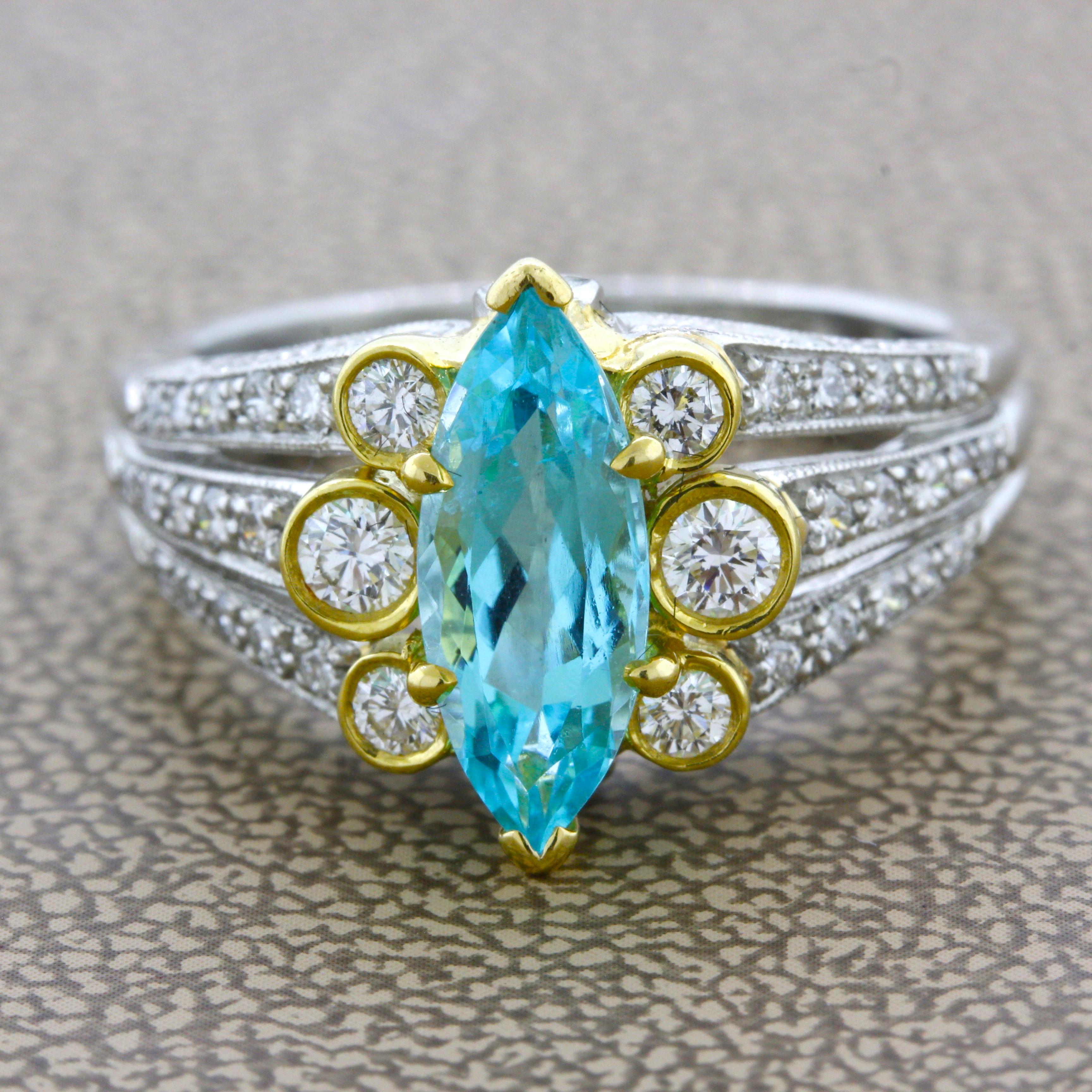 A rare and prized Paraiba tourmaline from Brazil takes center stage of this two-tone platinum gold ring. The reason for the rarity and desirability of Brazilian Paraiba is its unique neon electric color. This particular stone is no different as the