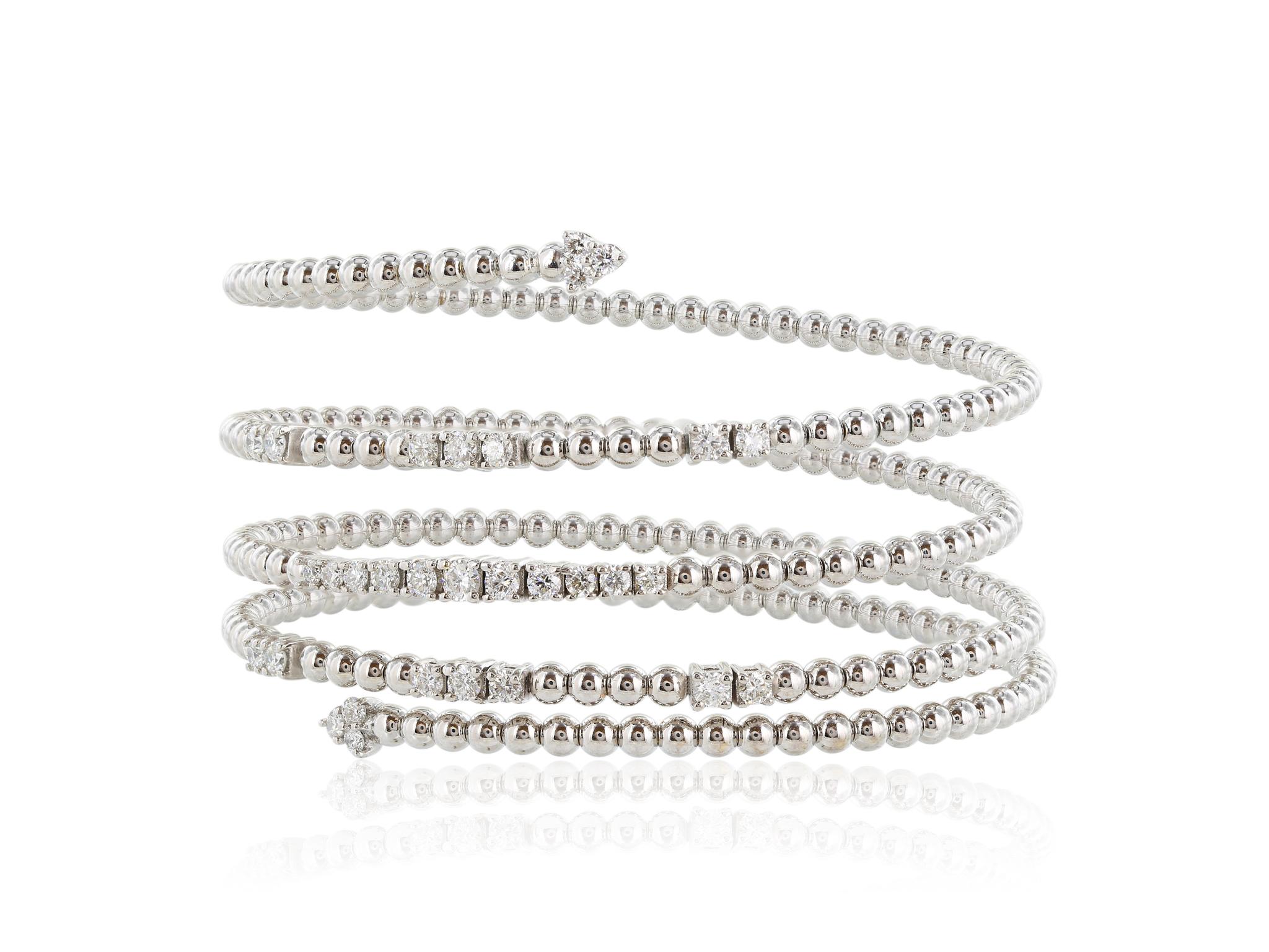 White gold wrap bracelet featuring 29 round brilliant cut diamonds that have a combined total carat weight of 1.57 carats with a color and clarity of G-H VS2-SI1 respectively. The bracelet features a bead chain styling.
