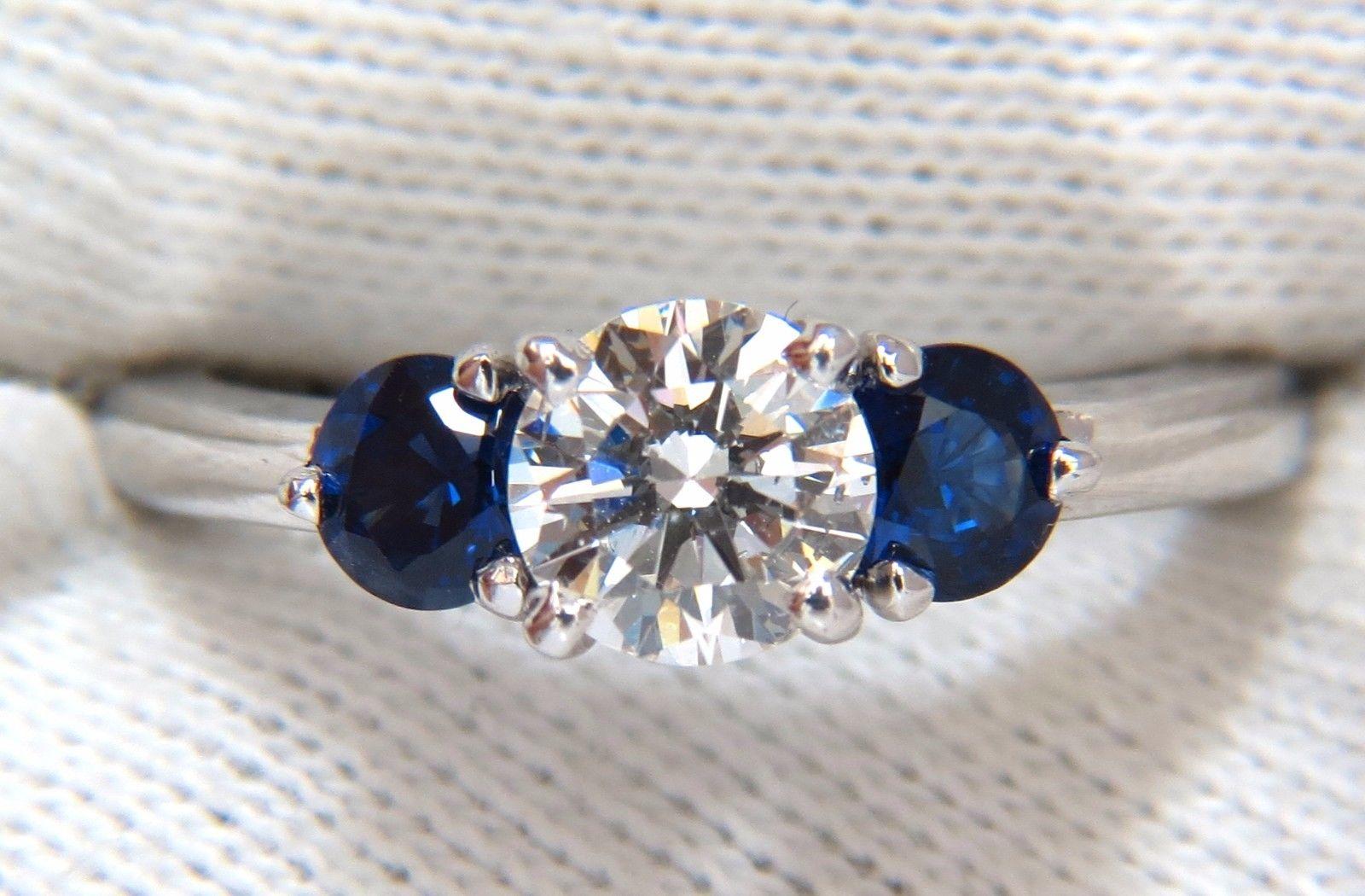 Classic Diamond & Sapphires, Three Stone

.77ct. Round Cut diamond

Full Cut Brilliant

G-color Si-1 Clarity

5.98mm



Side Round Natural Blue Sapphires: .80ct. 

Vibrant Royal Blue & transparent

Full cut and Full Faceted.

Gorgeous three stone