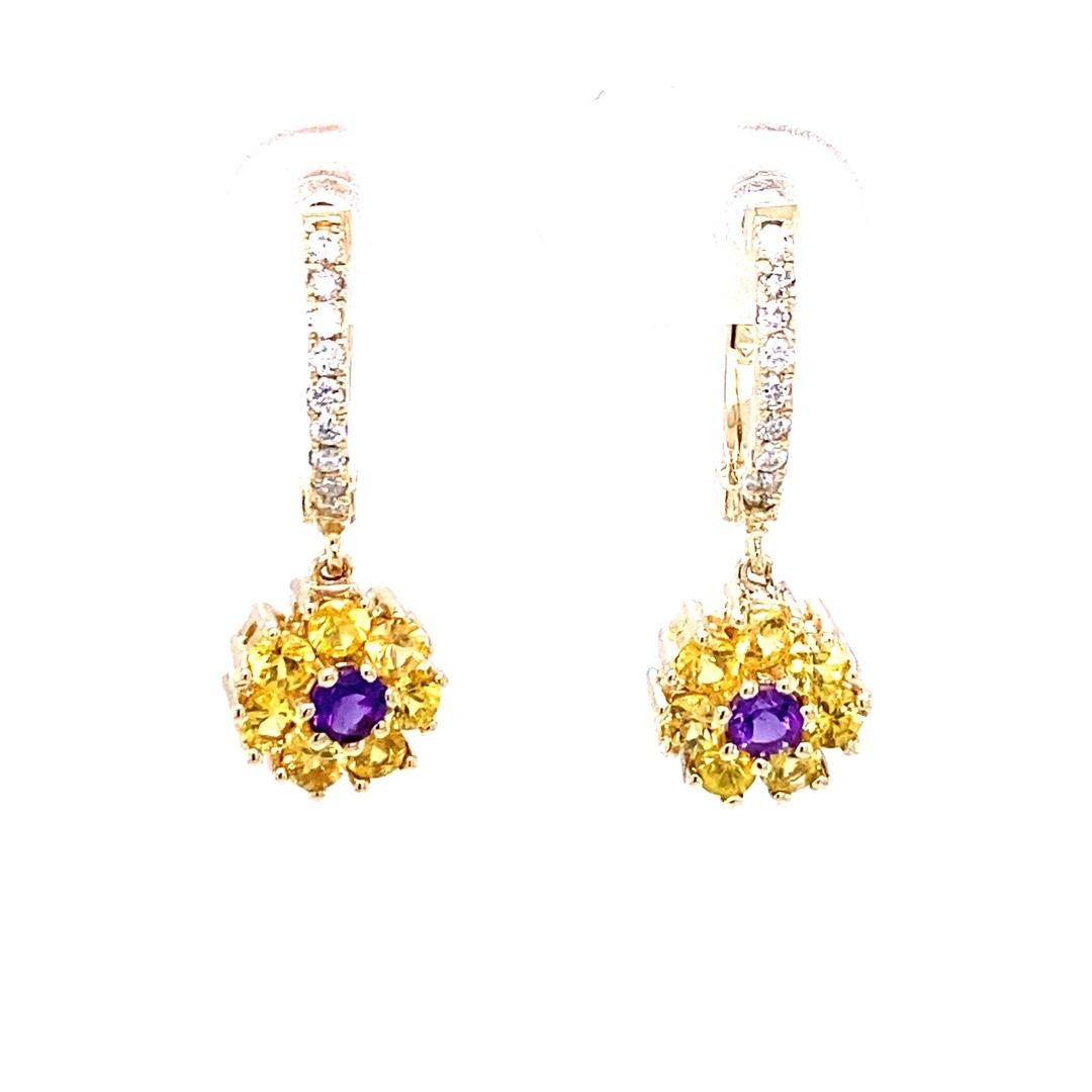 Yellow Sapphire, Amethyst and Diamond Drop Earrings

These cute and dainty earrings have 14 Yellow Sapphires and 2 Amethysts set in a flower like design that weigh 1.40 Carats and are embellished with 18 Round Cut Diamonds that weigh 0.17 Carats