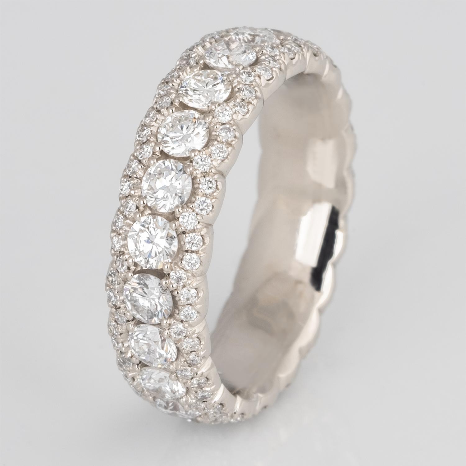 This delicate and sparkly scalloped eternity ring has 1.57 carats of diamonds hand set into a comfort fit band. It is super comfortable for an eternity ring with so many diamonds. 
The diamonds are expertly set and perfectly spaced which means each