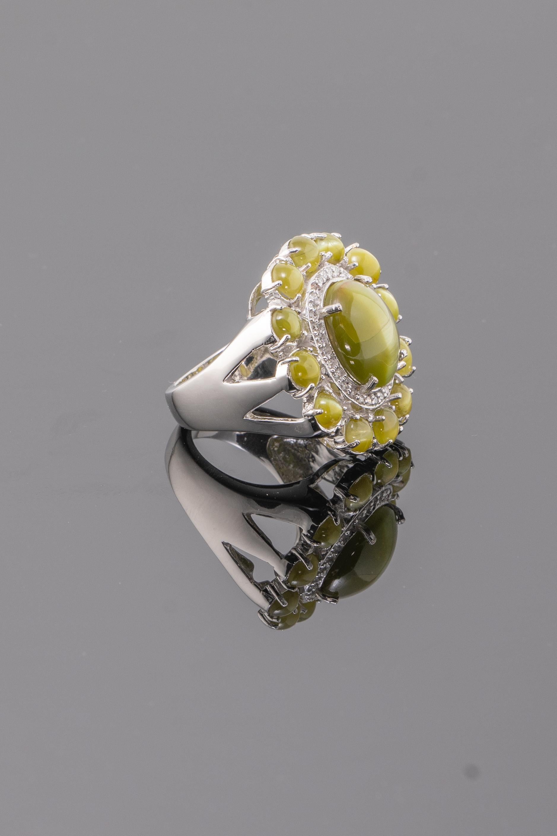 A very unique 15.70 carat Chrysoberyl Cats-Eye and 0.31 carat Diamond cluster cocktail ring, set in 15.15 grams solid 18K White Gold. Currently sized at US 7, can be resized. 
Message for more information and video! 
We accept returns. Free shipping