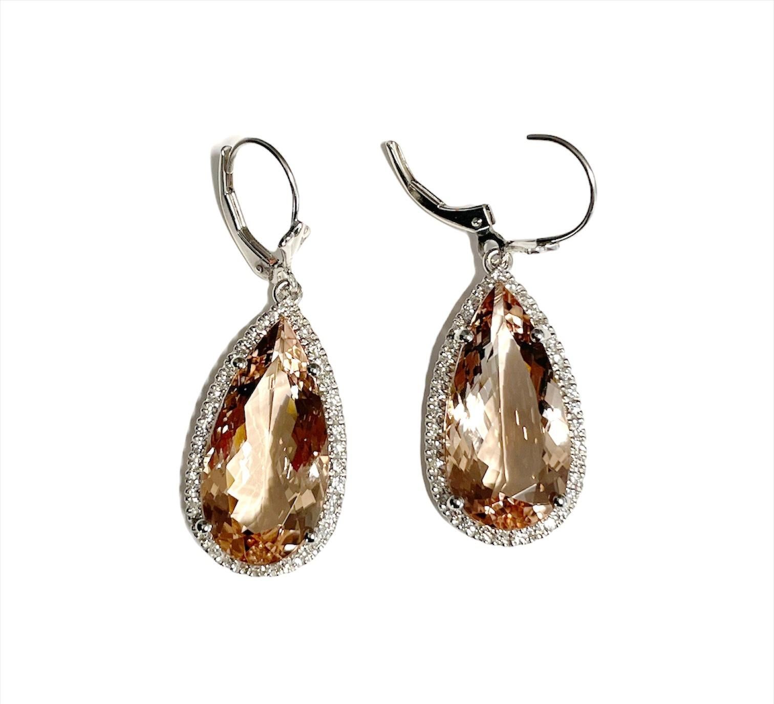 These gorgeous morganite diamond earrings feature 2 pear shape morganites weighing 15.73ct surrounded by 74 diamonds weighing approx. .55ct set in 14k white gold.