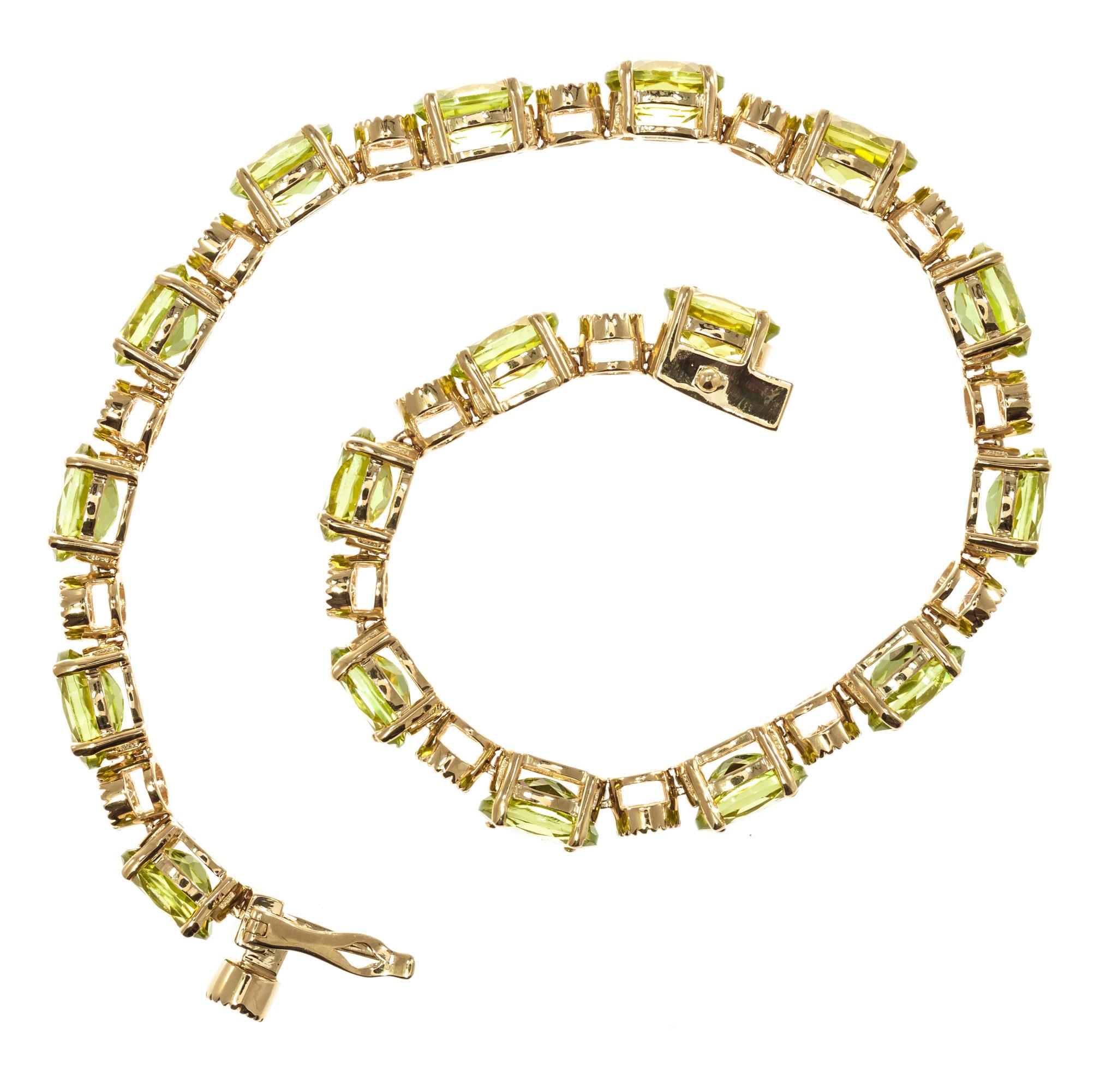 Peridot and diamond bracelet. Oval green peridot's separated by round bezel set diamonds. Set in 14k yellow gold. Built in box catch with figure eight safety 

17 oval bright green VS-SI peridots, Approximate 15.00 carats 
17 round brilliant cut H