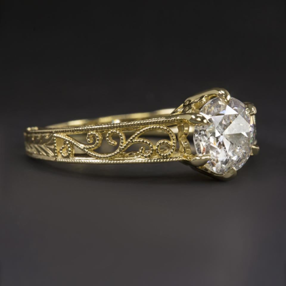 Vintage style diamond ring with a fantastic brilliant sparkle and a very classic design. The central diamond weighs 1.57 carats and is an old European cut diamond. It is bright and vibrant white and this is a rarity among the diamonds of its period.