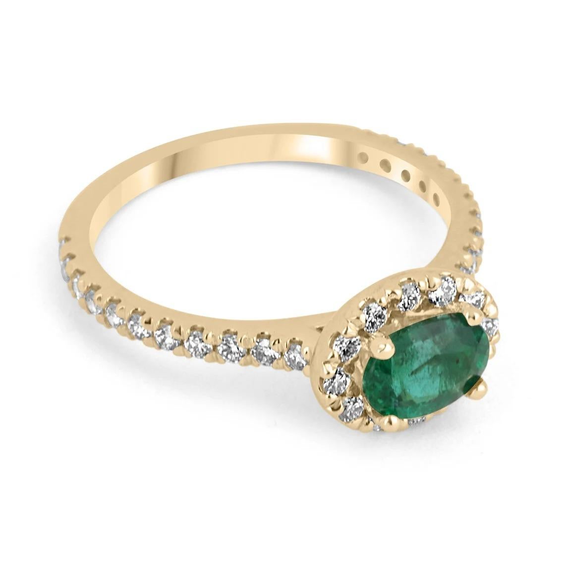 A stunning emerald & diamond ring. The center stone features a beautiful 1.15-carat, natural emerald cut in the shape of an oval. The gem stone has a desirable dark green color, with very good to excellent eye clarity. Set east to west; and