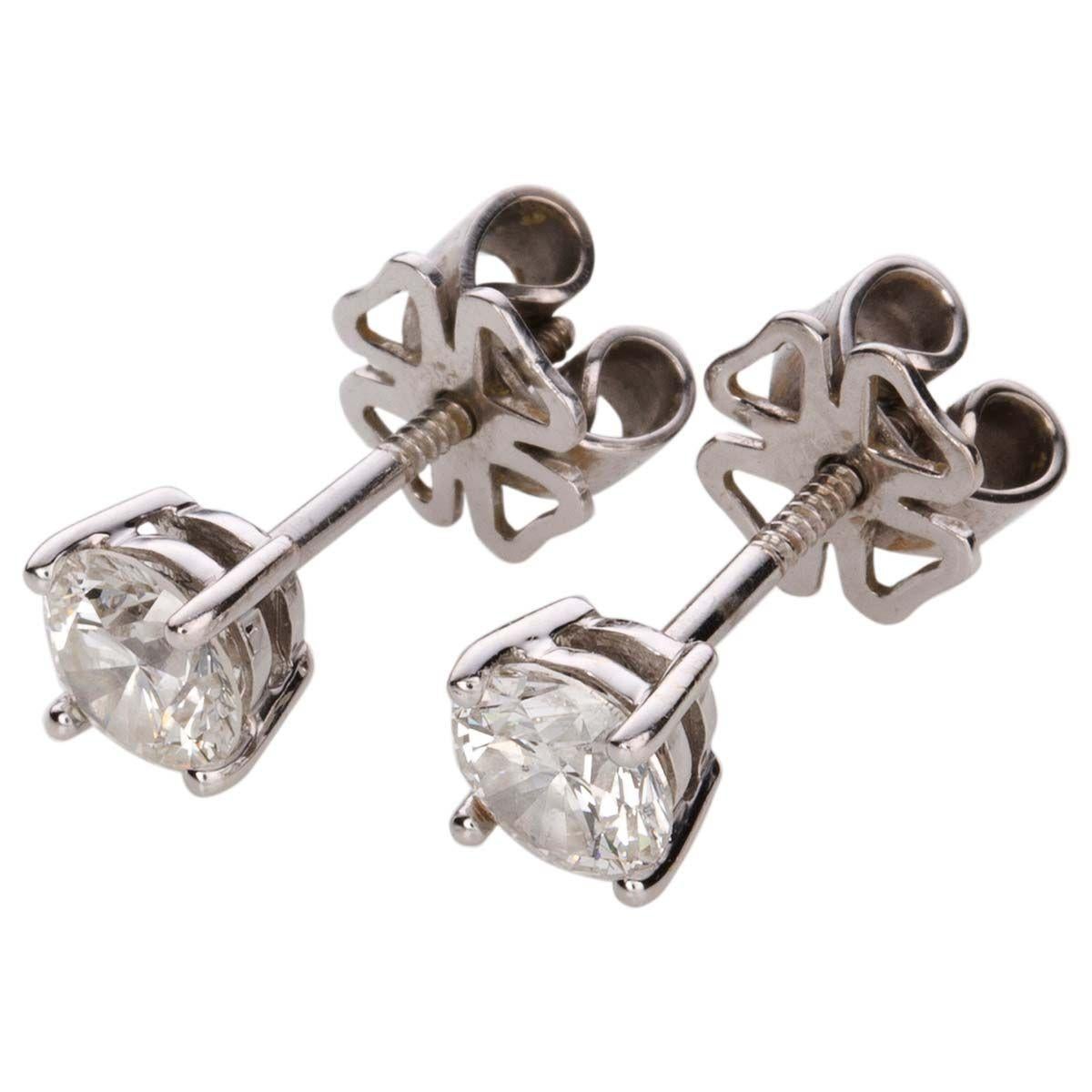 Simple, elegant and ready for everyday wear these modern round brilliant cut diamond ear studs are mounted in 18k white gold in a four claw setting with threaded post fittings and heavy duty butterfly clips. 
Each diamond weighs 0.79cts, G/H colour,