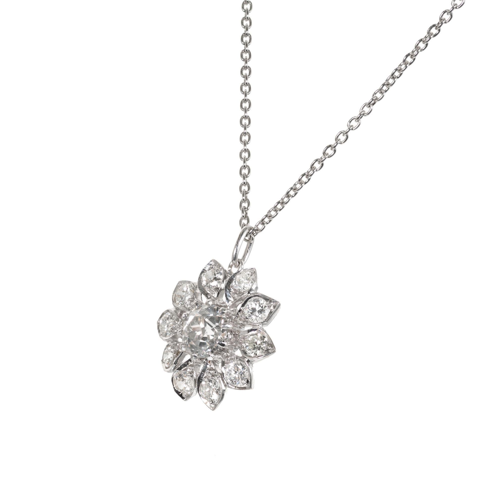 Handmade diamond platinum flower pendant on a 16 Inch platinum chain.

1 old European cut diamond L SI approx.  .78cts
10 round diamonds J-K SI 2, approx. .80cts
Platinum 
6.3 grams
Top to Bottom: 16.98mm or 11/16 Inches
Width: 16.5mm or 10/16