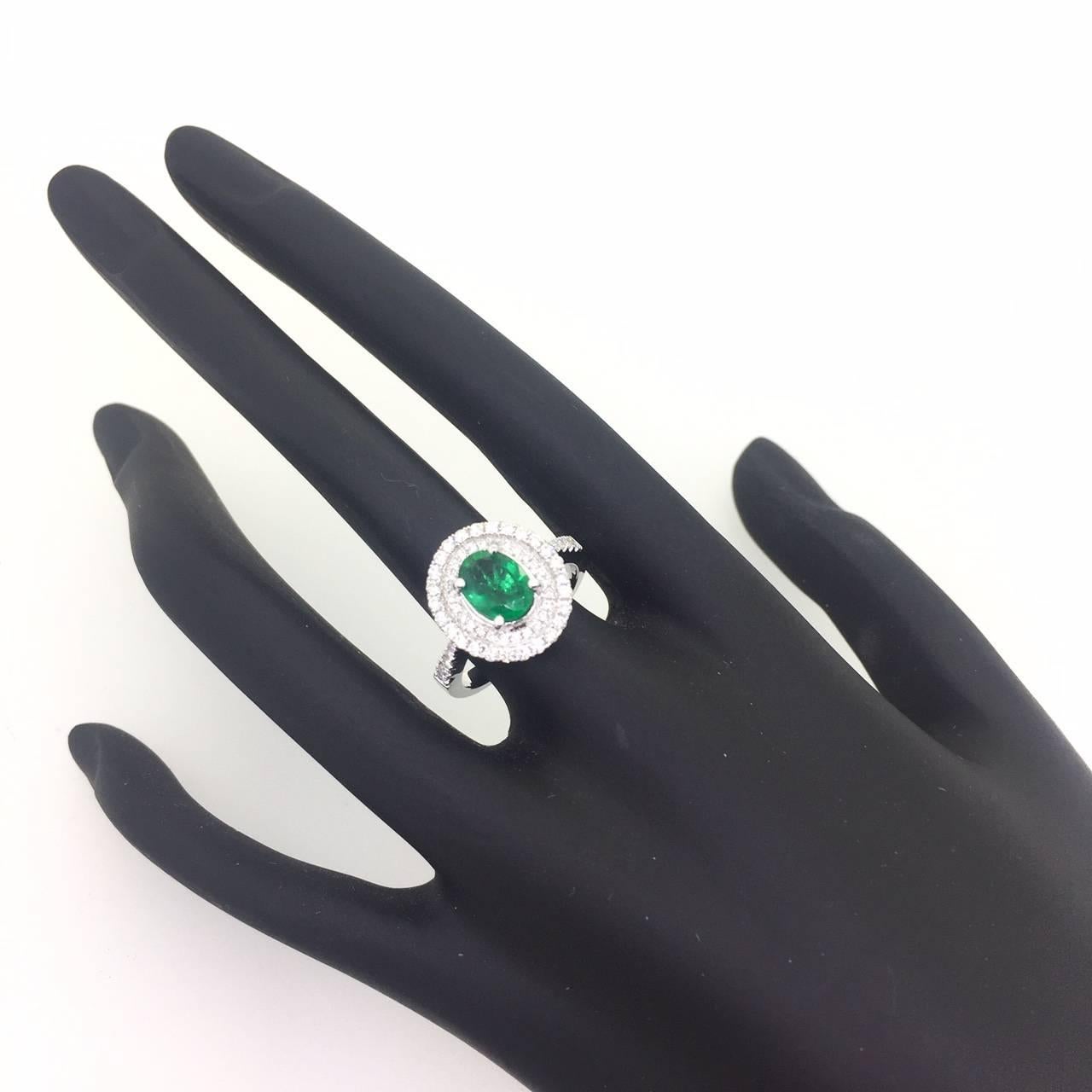 Oval Cut 1.58 Carat Emerald and Diamond 18 Karat White Gold Engagement Ring For Sale