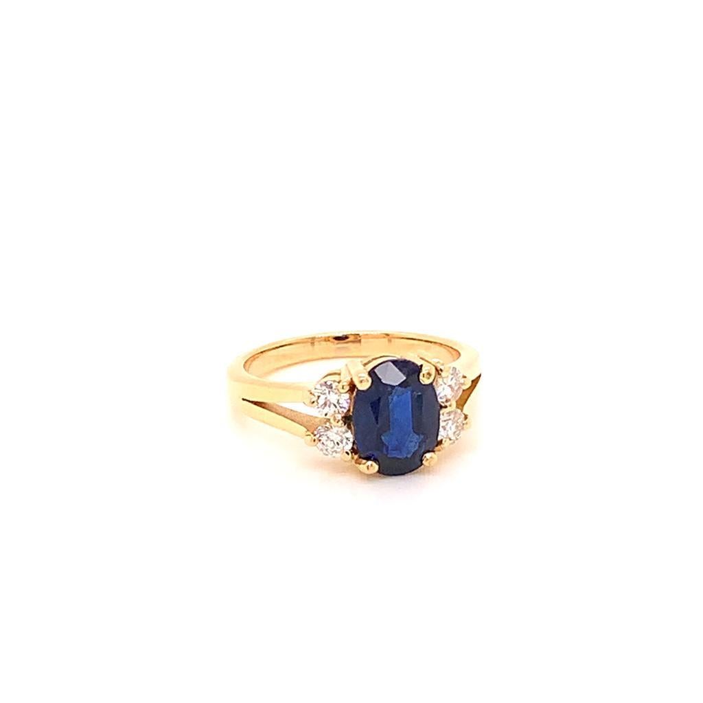 This Alluring ring features an immaculate 1.58 Carat Oval cut Blue Sapphire at its centre held in place by a four-prong setting and complimented perfectly by the four scintillating round brilliant diamonds surrounding it which weigh a total of