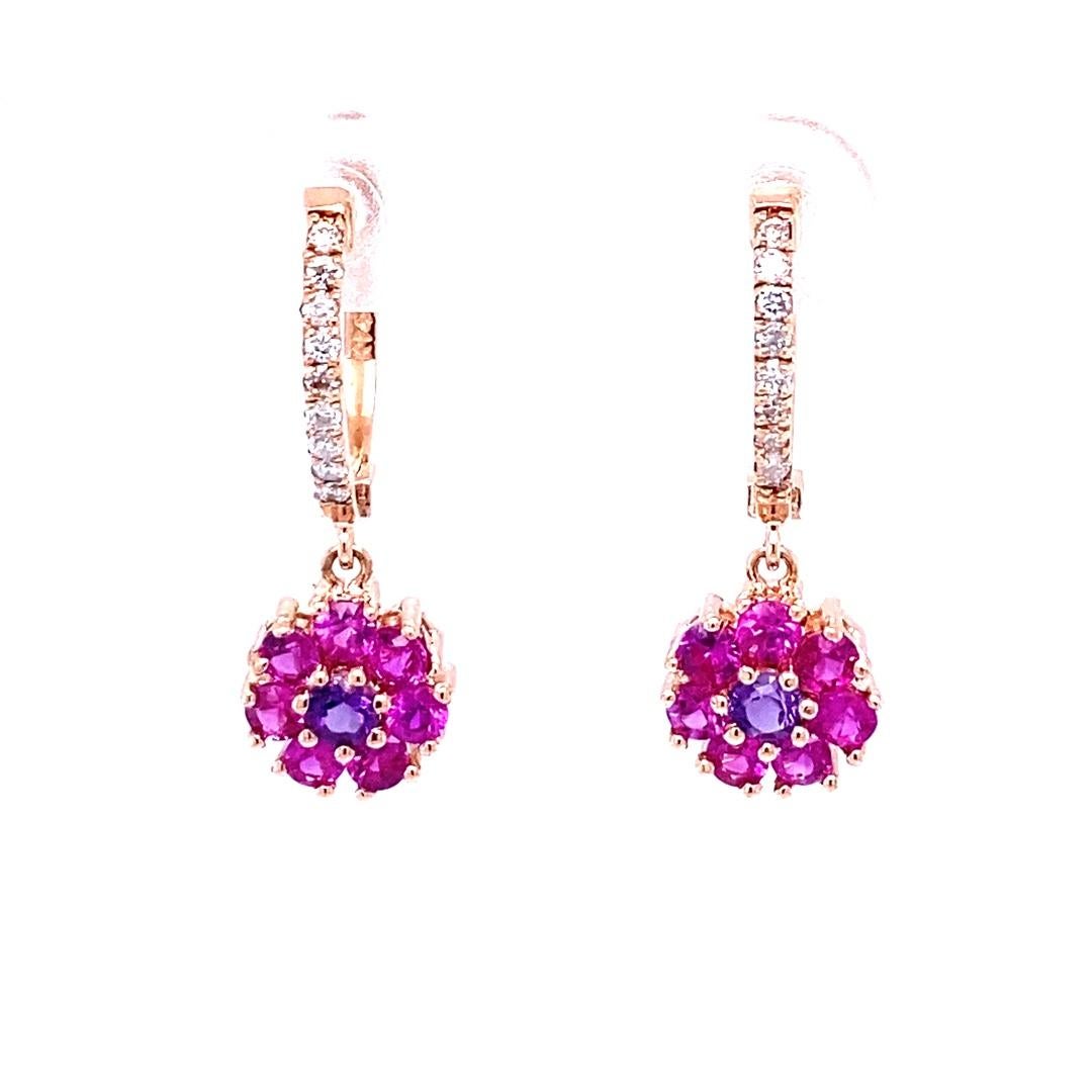 Pink Sapphire, Amethyst and Diamond Drop Earrings! 

These cute and dainty earrings have 14 Pink Sapphires and 2 Amethysts set in a flower like design that weigh 1.41 Carats and are embellished with 18 Round Cut Diamonds that weigh 0.17 Carats