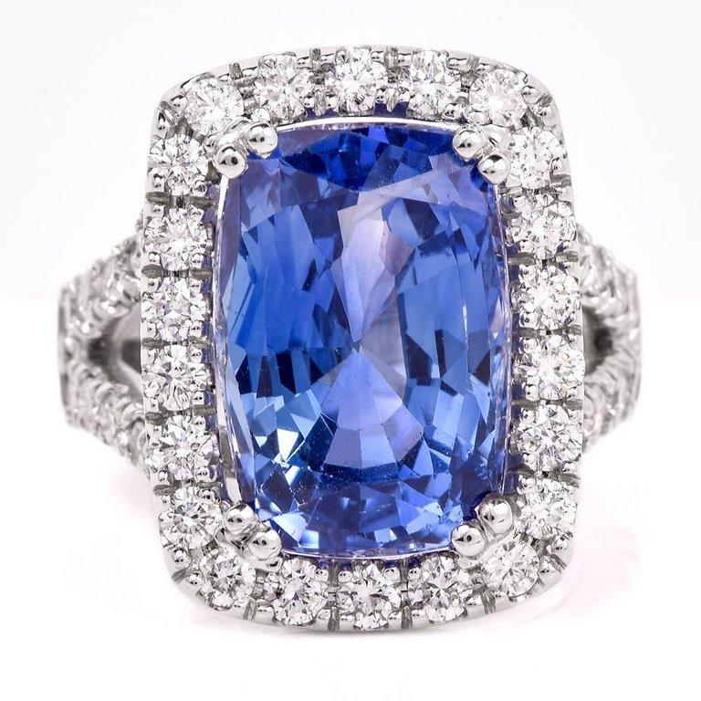 This spectacular sapphire and diamond cocktail ring are crafted in solid 18-karat white gold, weighing 12.3 grams and measuring 21mm x 20.50mm. Showcasing one GIA lab reported natural cushion-shape blue sapphire, with no heat or treatments, weighing