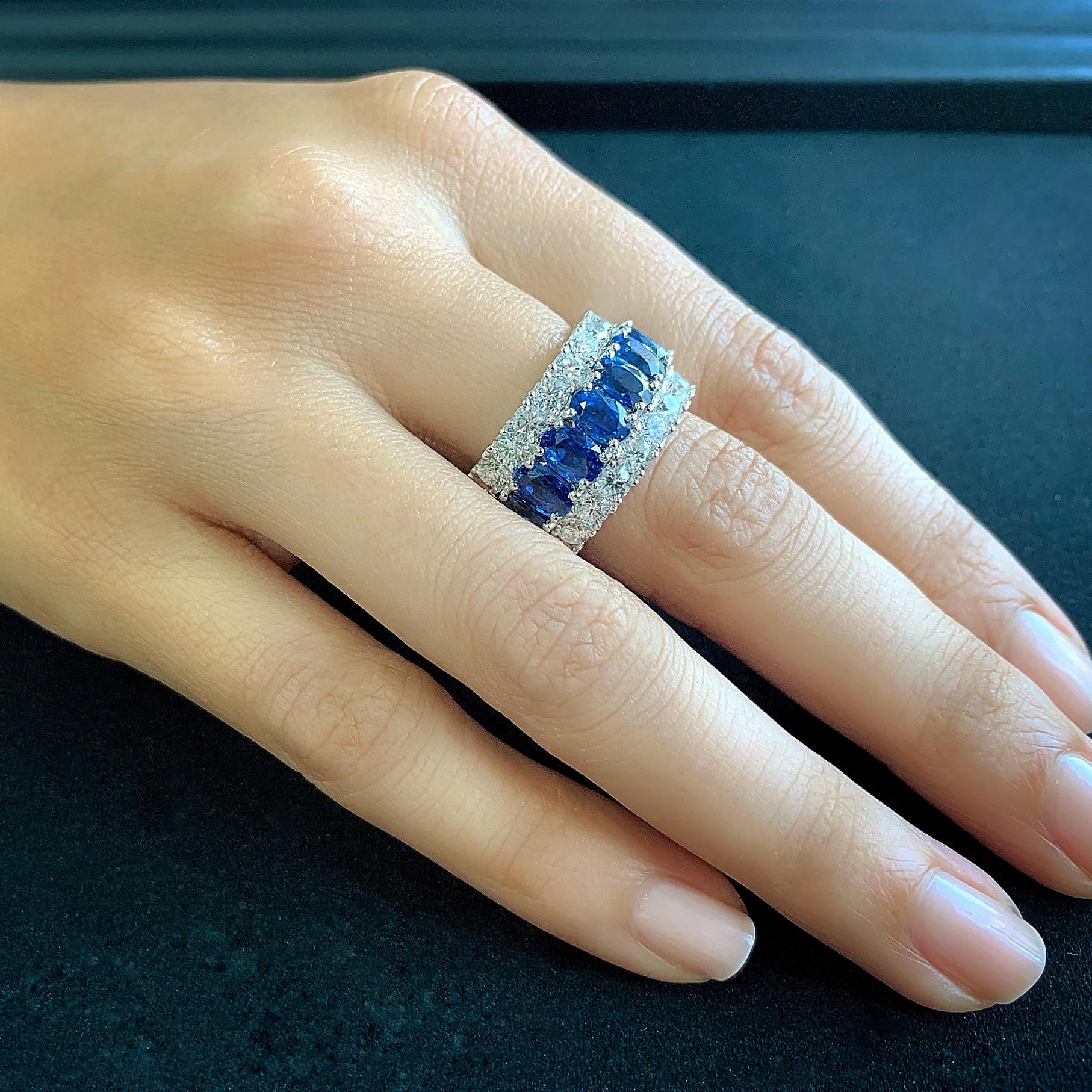 Butani's stunning diamond eternity band ring features a center row of oval blue sapphires (totaling 10.79 carats) and two rows of brilliant-cut round diamonds (totaling 5.01 carats).  Set in 18K white gold.  A classic and timeless piece.  Currently