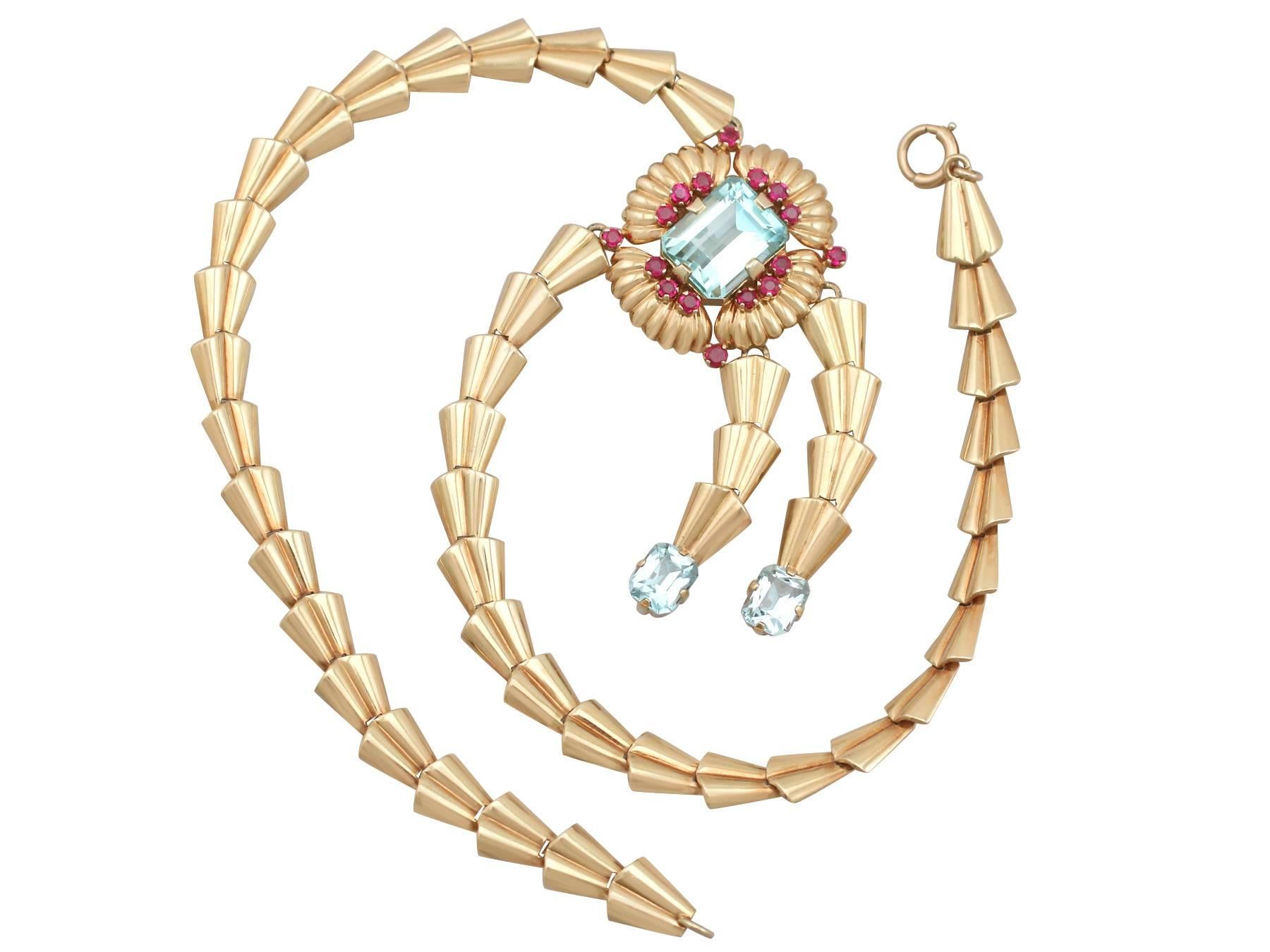 A stunning vintage Art Deco 15.84 Ct aquamarine and 1.28 Ct ruby, 14k yellow gold necklace by Tiffany & Co; part of our diverse gemstone jewelry collections.

This stunning, fine and impressive Tiffany & Co. necklace has been crafted in 14k yellow