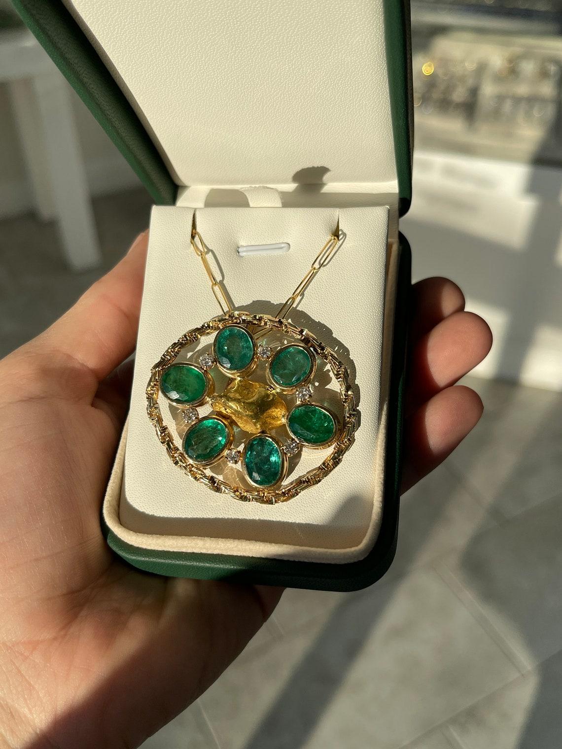 Elevate your style with our exquisite Natural Emerald & Diamond Brooch, a harmonious blend of nature's beauty and unparalleled craftsmanship. Adorned with six mesmerizing oval-cut Zambian emeralds, ranging from medium to rich green hues, each