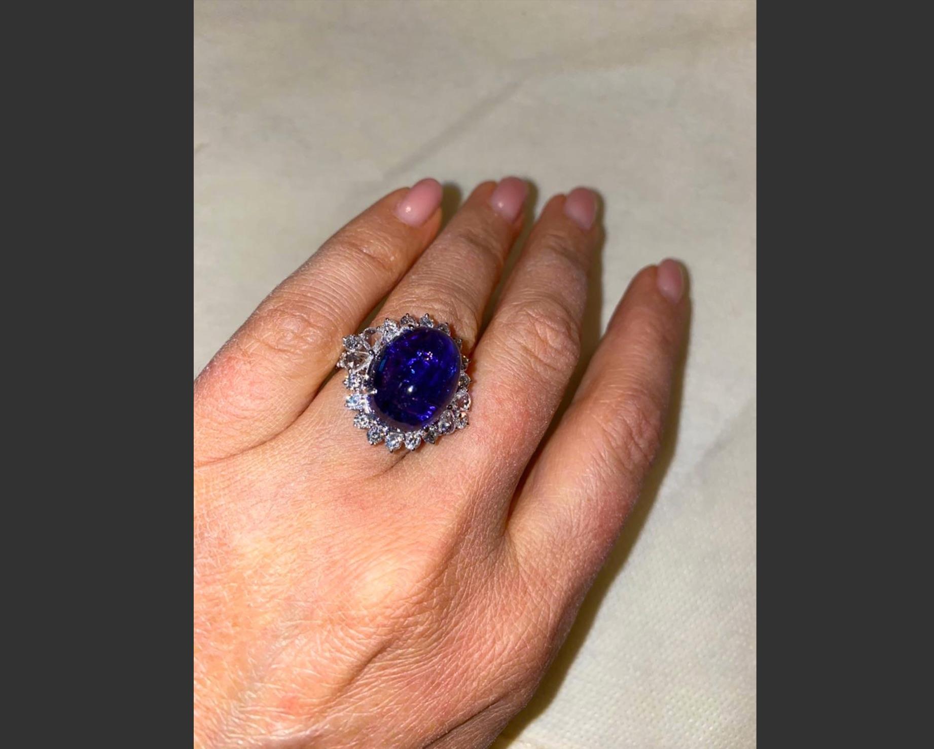 A gorgeous Tanzanite and Diamond cocktail ring, with a lustrous 15.86 carat Tanzanite centre stone and 1.32 carat colorless Diamonds. The stones are set in 3.28 grams solid 18K Gold. 

