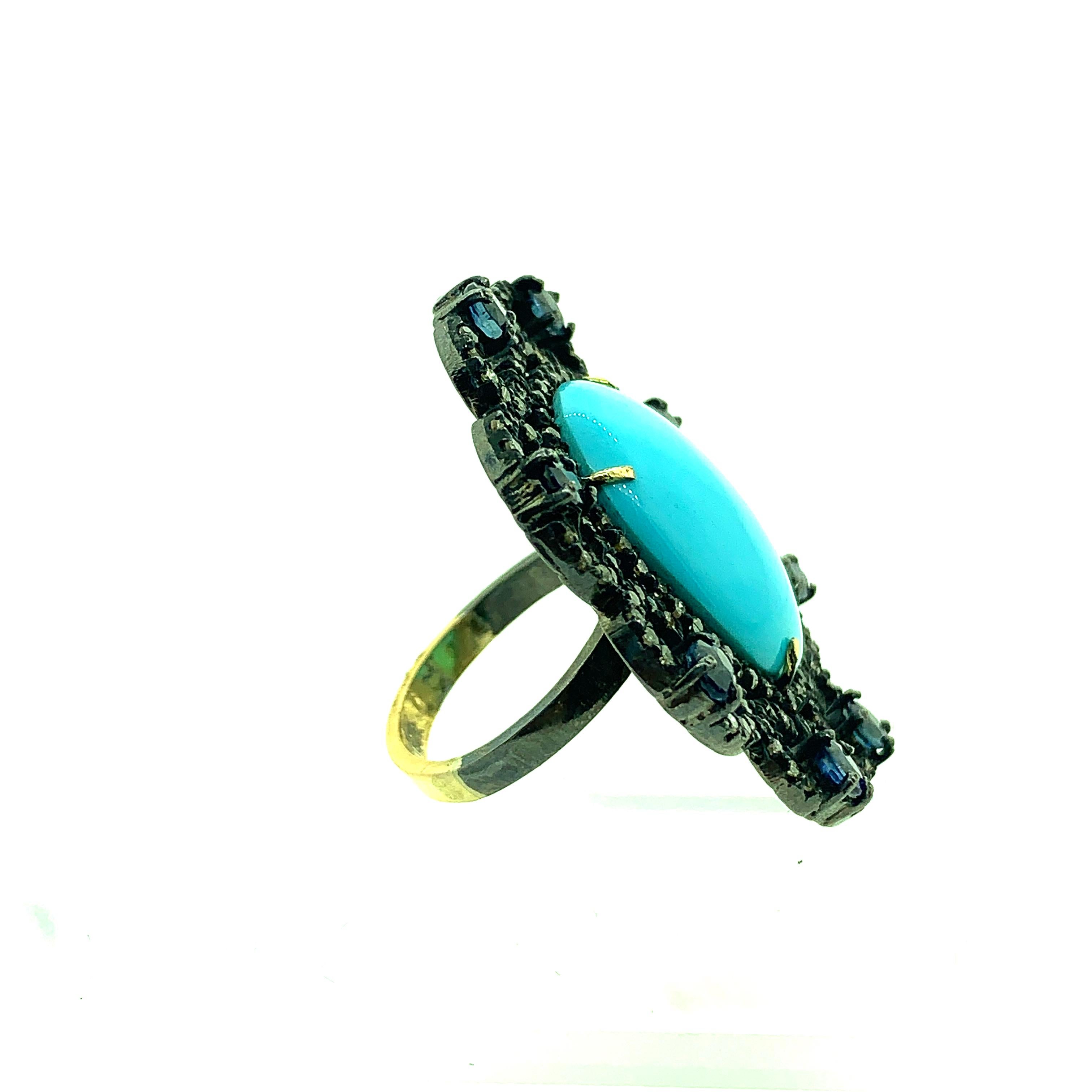 15.86 ct Turquoise , 2.17 ct Sapphire and 1.77 ct  Pave Champagne Diamond Ring set in Oxidized Sterling Silver with half ring shank in 14KT Gold. The turquoise is natural and real stone set by four 14Kt Gold Prongs. The sapphire stone in ring are