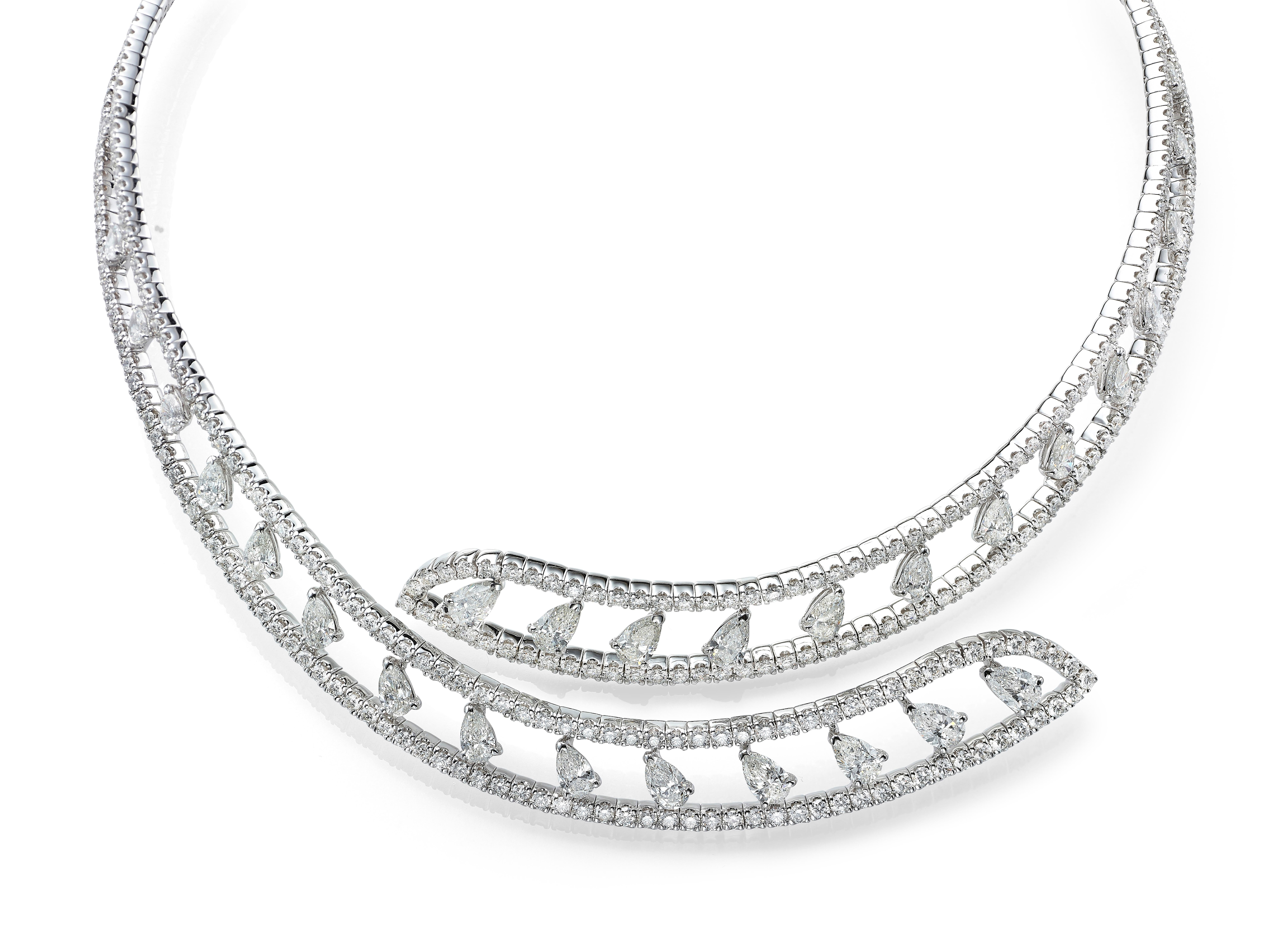 A quintessential piece for special occasions, Butani's open collar choker necklace is skillfully crafted from 18K white gold.  The open bar design is set with 9.06 carats of white pavé  diamonds and punctuated with 27 pear cut diamonds totaling 6.82