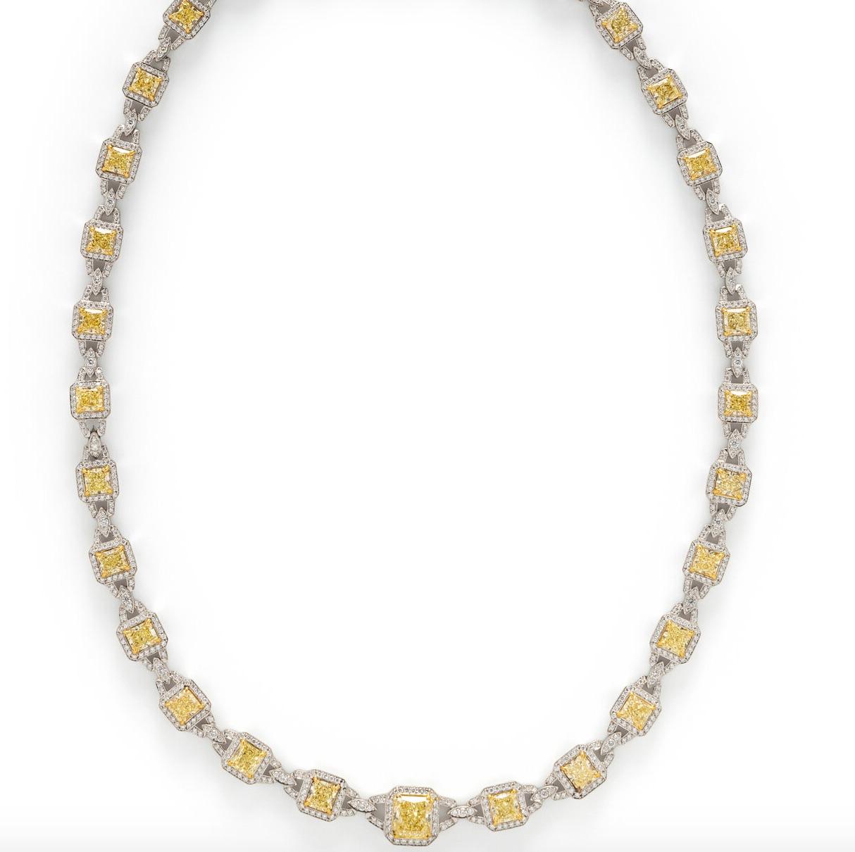 This gorgeous necklace consists of a central GIA graded 2.02 carat natural fancy yellow radiant cut diamond, together with approximately 13.86 carats of radiant cut yellow diamonds surrounded by numerous round brilliant cut diamonds weighing
