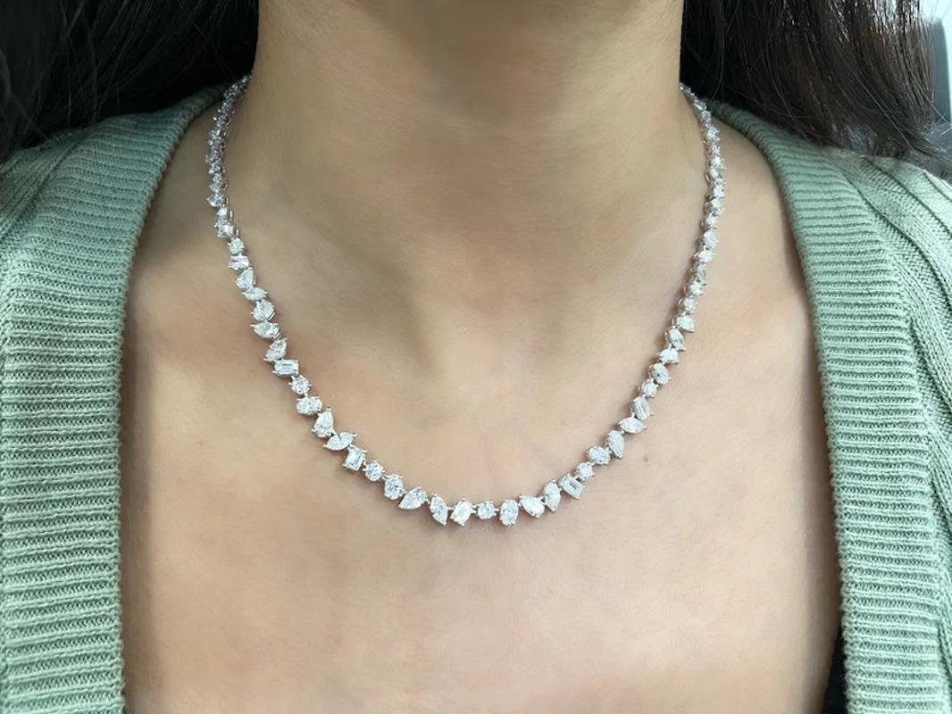 This stunning fancy diamond necklace features 94 diamonds weighing 15.89cts set in 18k white gold. The diamonds are E-F in color and VS1-VS2 in clarity.

Diamond Weight: 15.89 ct
Diamond Quality: E-F, VS1-VS2
Diamond Shapes: Round, Oval, Pear,