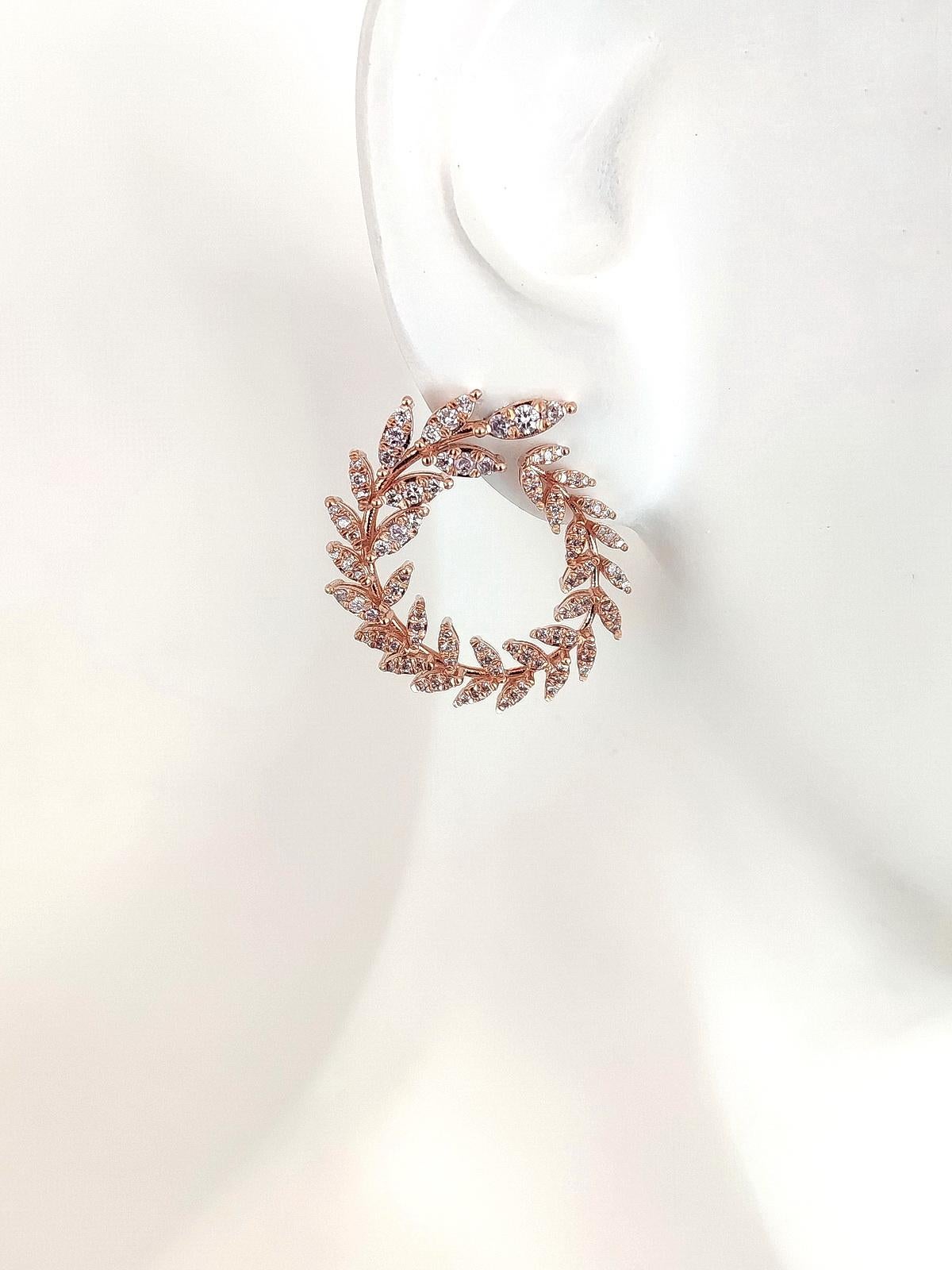 FOR U.S. BUYERS NO VAT 

204 sparkling round brilliant pink diamonds, totaling 1.58 carats, are set in 14kt pink gold in such a way that their unique combination creates a chain of leaves-like design shaped as circles. The earrings make a very