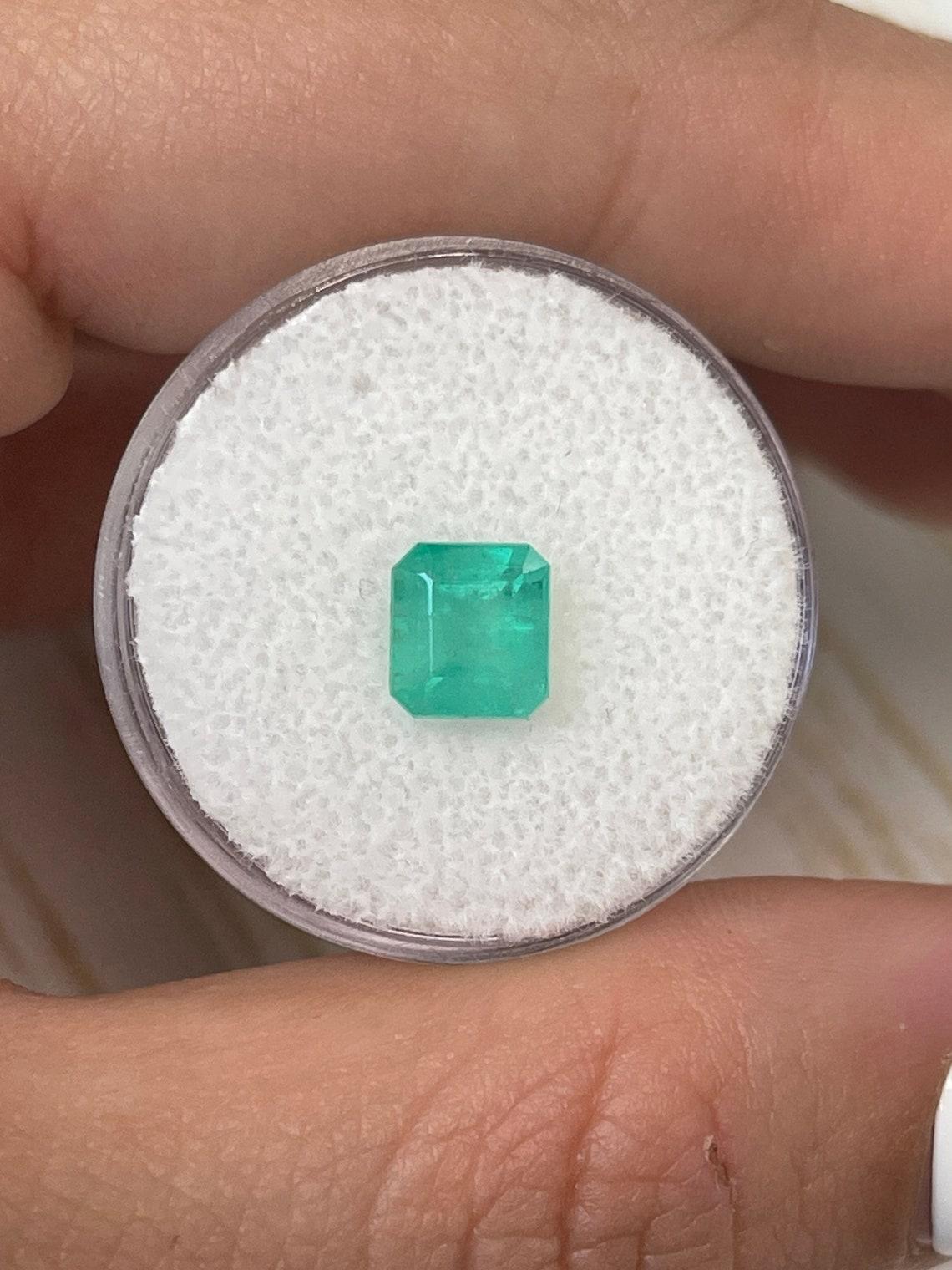 Stone: Emerald
Weight: 1.58-carats
Shape: Asscher Cut
Clarity: Translucent
Luster: Good
Color: Medium Bluish Green
Measurements: 7.01mm x 6.35mm x 5.34mm
Geographic Origin: Colombia
Treatment: Natural, Oiling

Comments: Due to their growth