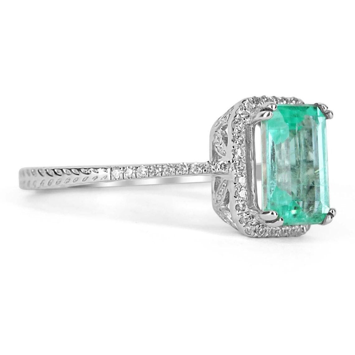 Featured is a stunning natural rare natural emerald and diamond pave halo engagement ring 14K. The center gemstone is a fine, bright blue-green, emerald skillfully handset in a 14K white gold double prong setting. This unique natural gemstone has