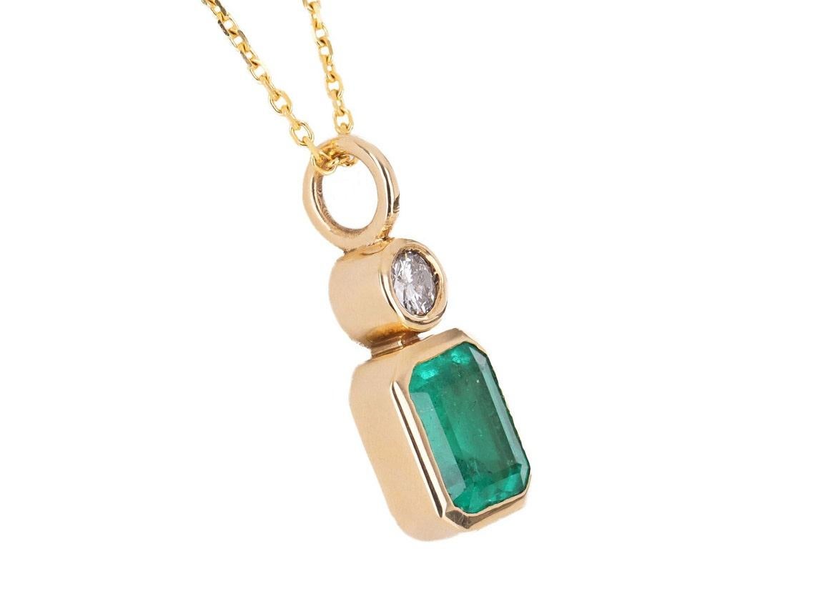 Captivate your eyes on this stunning, emerald and diamond pendant. The emerald has a full 1.41-carats of vivid green color and excellent luster. Accented at the top of the stone, is a 0.17-pointer, brilliant round diamond with superb shine. Securely