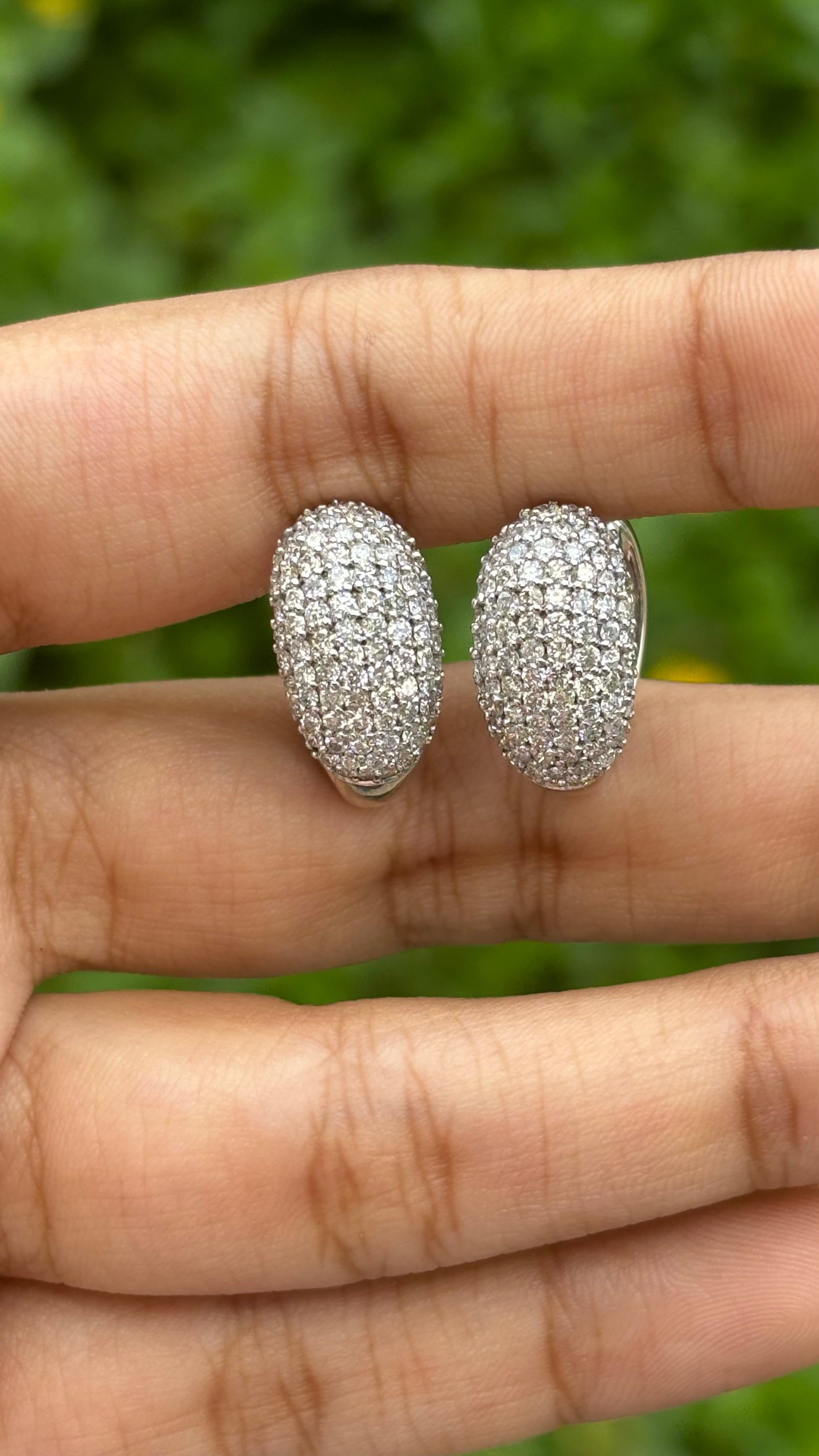 An extremely extravagant yet classic pair of jewelry featuring these exquisite and elegant, natural diamond earrings. These 18K White Gold Earrings weigh 7.2 grams and are studded in the front with a total of 1.59 Carat Natural Diamonds.

The