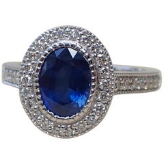 1.59 Carat Oval Sapphire Ring with 0.45 Carat of Diamond in 18 Karat White Gold