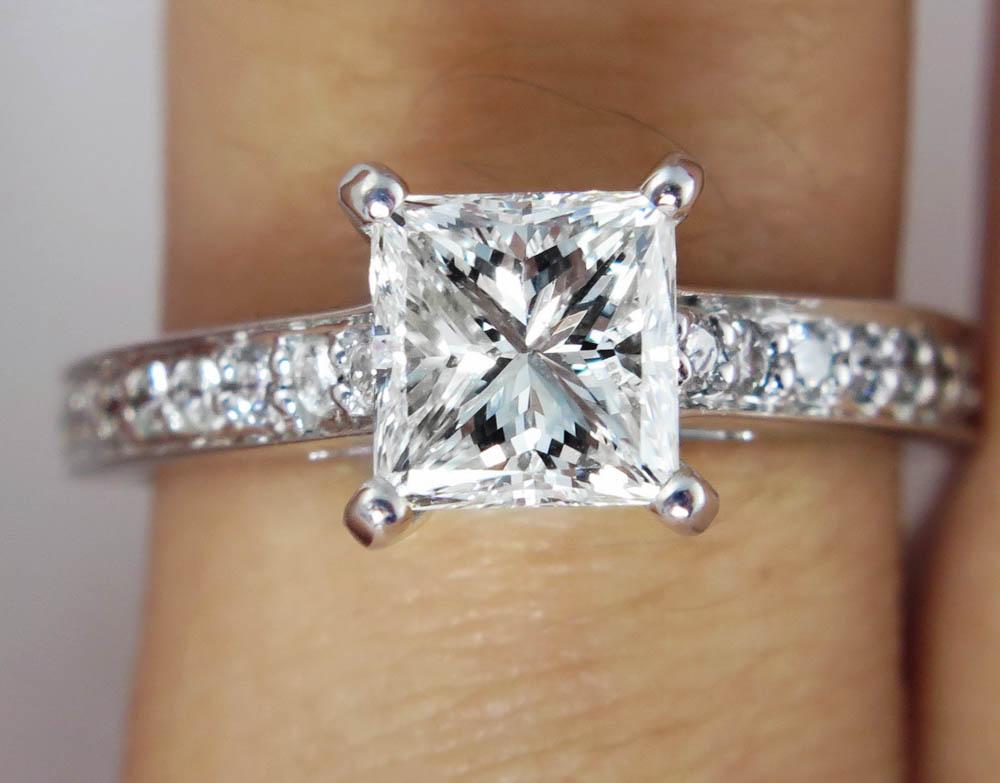 A Timeless Estate Vintage 18k White Gold (stamped) Engagement ring with EGL USA Certified 1.14ct PRINCESS Cut Center Diamond in I-J color SI1 clarity (Appears White, eye clear) set with 18 Round Brilliant side Diamonds, totaling to estimated 0.45ct,