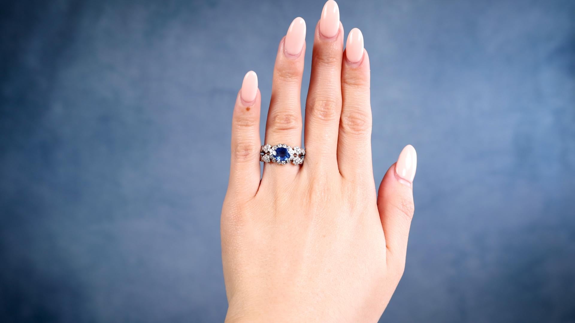 One 1.59 Carat Sapphire and Diamond Platinum Ring. Featuring one oval mixed cut sapphire of 1.59 carats. Accented by 72 round brilliant cut diamonds with a total weight of 0.65 carat graded colorless, VS-SI clarity. Crafted in platinum with purity