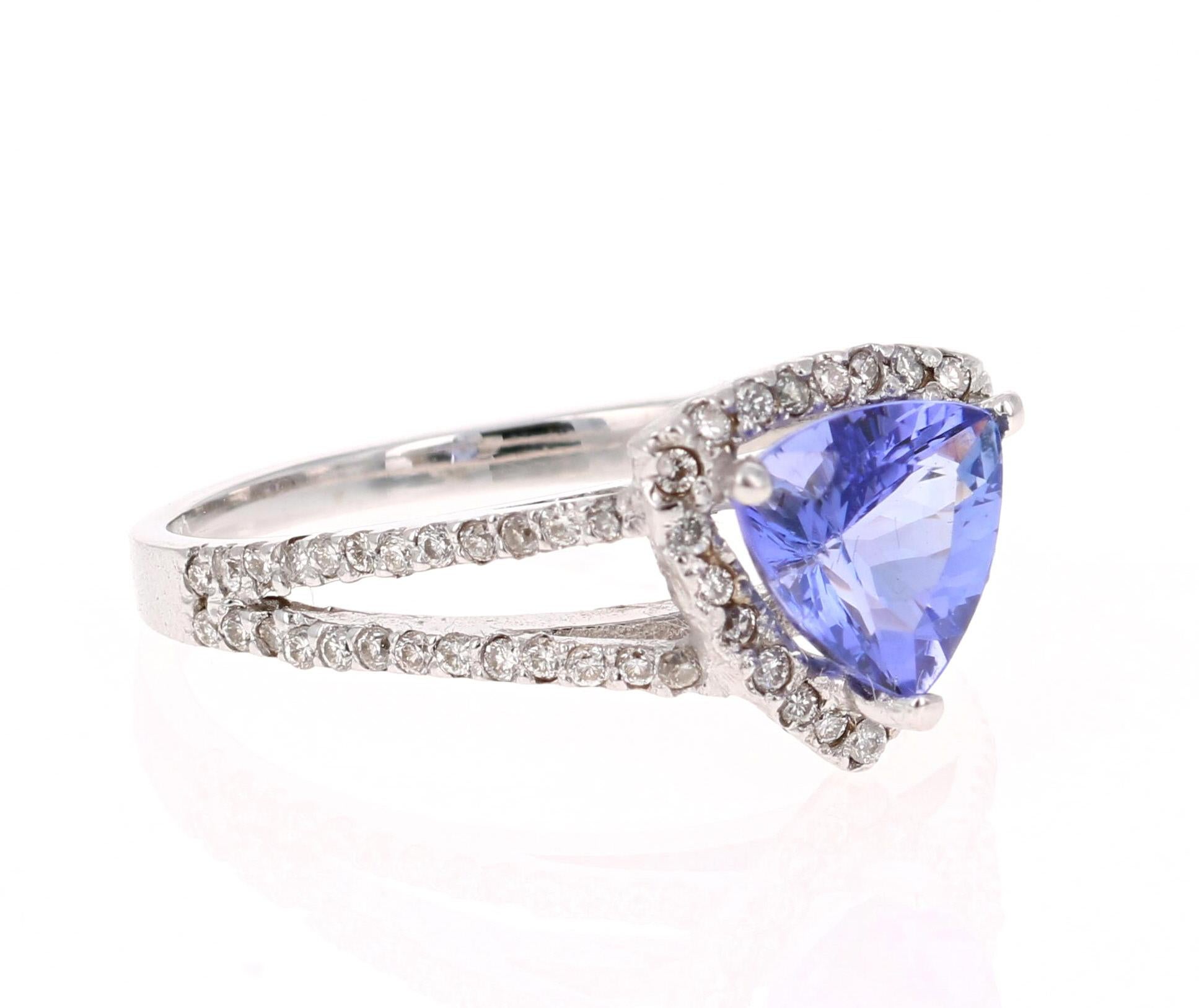 This cute ring has a 1.22 Carat Trillion Cut Tanzanite that is set in the center of the ring. The Tanzanite is surrounded by a halo of 79 Round Cut Diamonds that weigh 0.37 carats. The Total Carat Weight of the ring is 1.59 Carats. 

The ring is