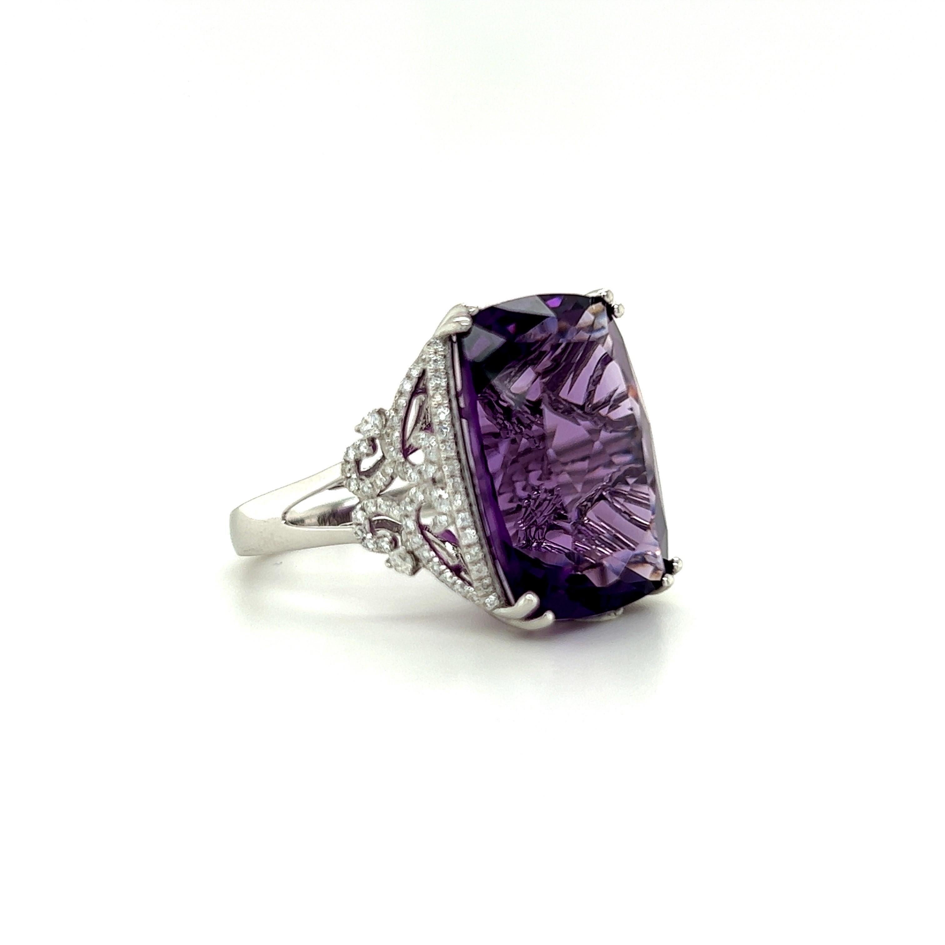 Glamorous amethyst cocktail ring. High brilliance, transparent clean, cushion faceted, rich eggplant purple tone natural 15.91 carats amethyst mounted in high profile open basket with eight bead prongs. Accented with round brilliant diamond.