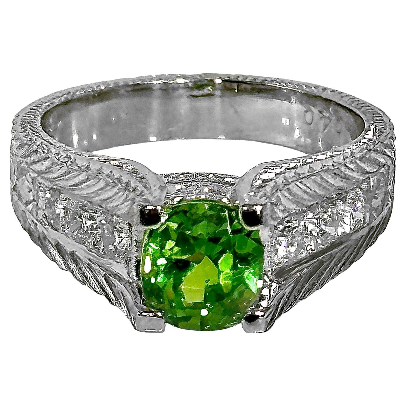 This glistening 1.59ct cushion cut Demantoid Garnet is one of natures delightful rarities. It is set in a striking modern platinum mounting.  There are six brilliant cut diamonds weighing 40ct total of overall H color and VS2 clarity set into the