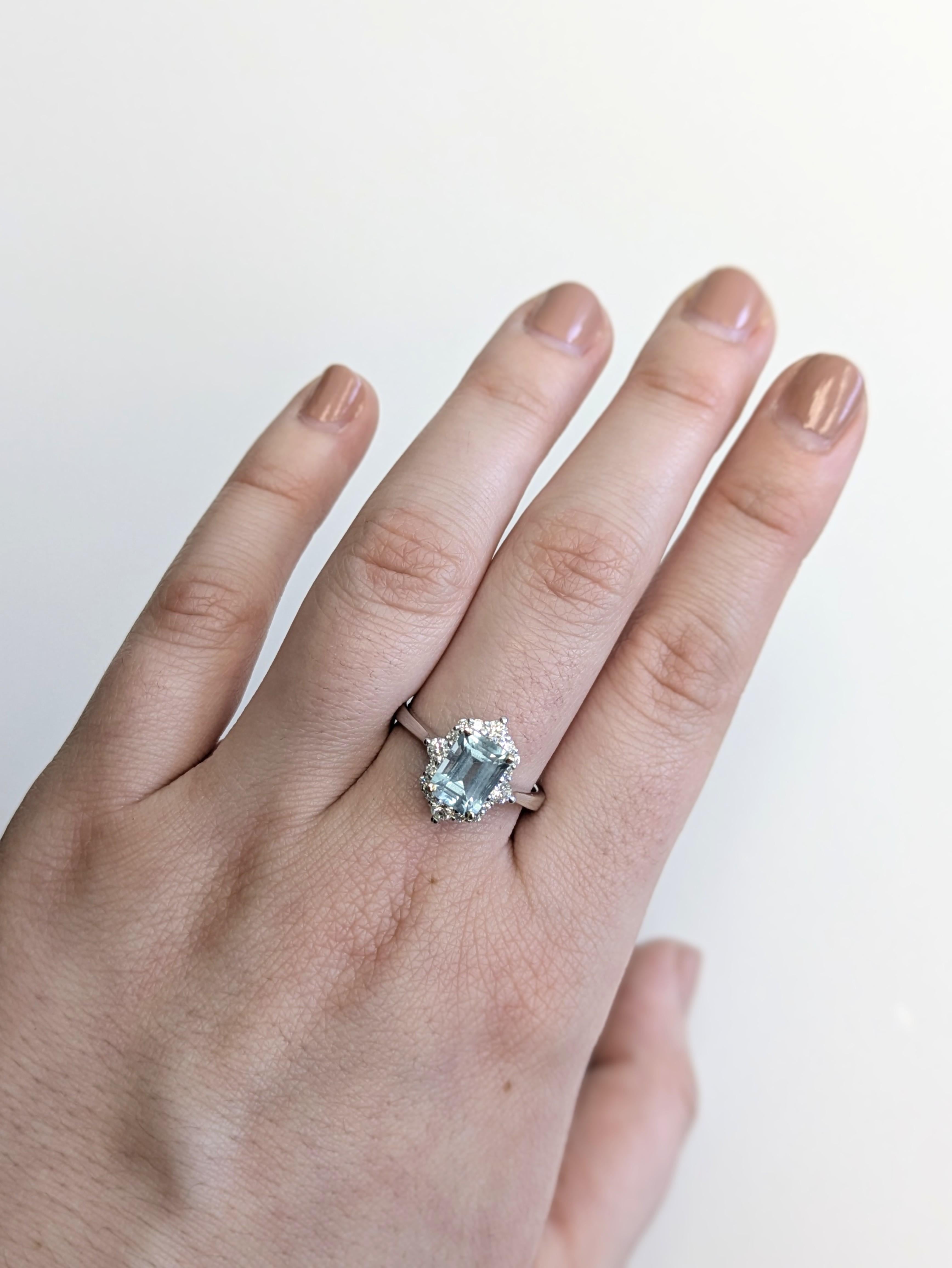 This pretty ring features a 1.5 carat emerald-cut aquamarine glowing with icy blue beauty, encircled by earth-mined diamonds. Set in solid 14k real gold, it’s effortlessly elegant—perfect for everyday sparkle or special occasions. Aquamarine does