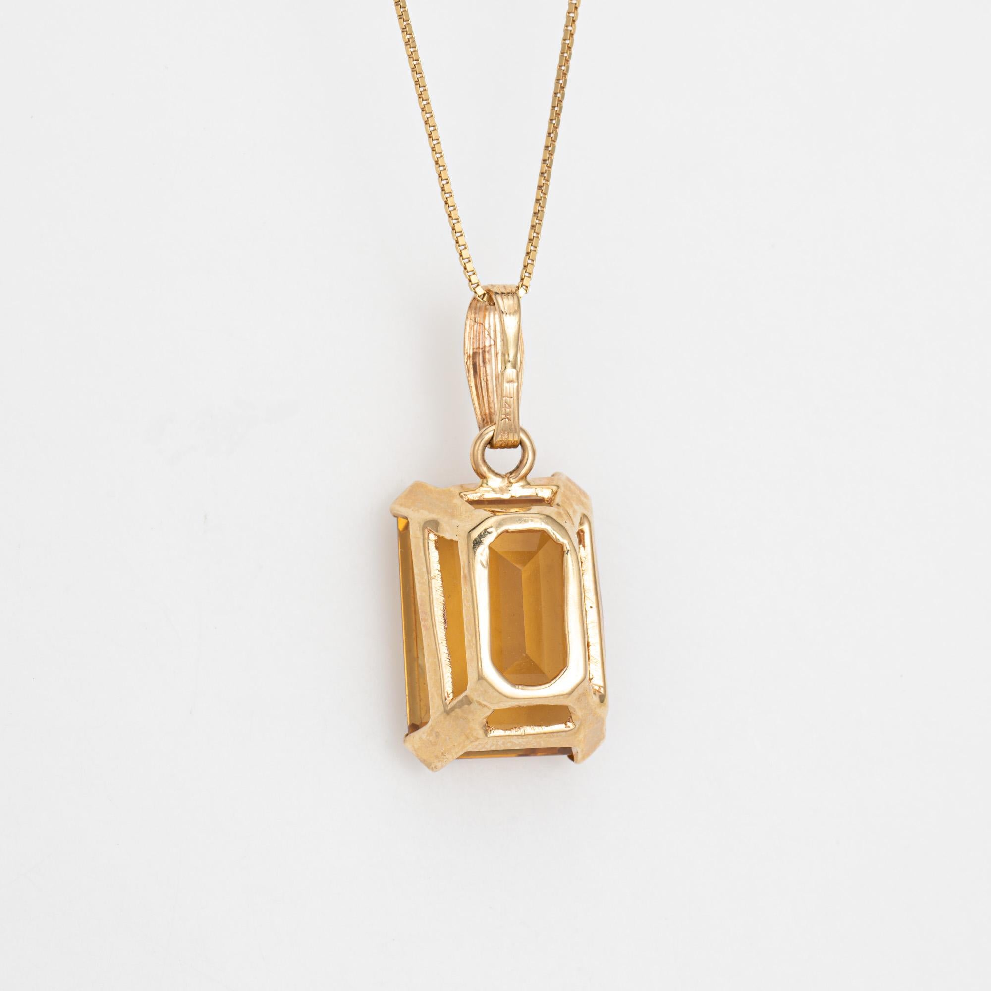 Finely detailed citrine pendant & necklace crafted in 14 karat yellow gold (circa 1960s to 1970s). 

Emerald cut citrine measures 18mm x 13mm (estimated at 15 carats). The citrine is in good condition and is free of cracks or chips (few light