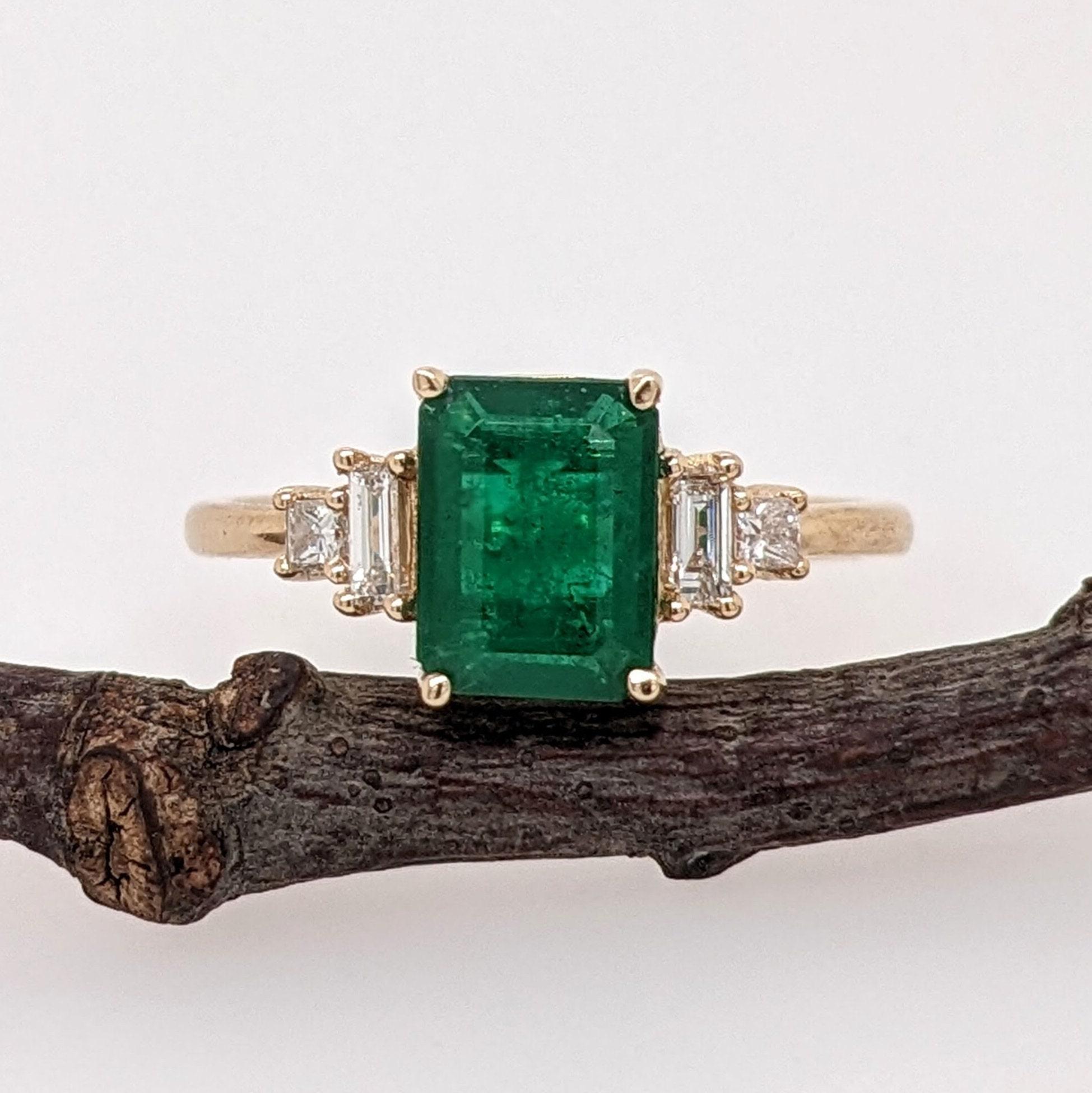 A vivid green emerald looks exquisite in this elegant minimalist ring with cute diamond accents.  A statement ring design perfect for an eye catching engagement or anniversary. This ring also makes a beautiful May birthstone ring for your loved