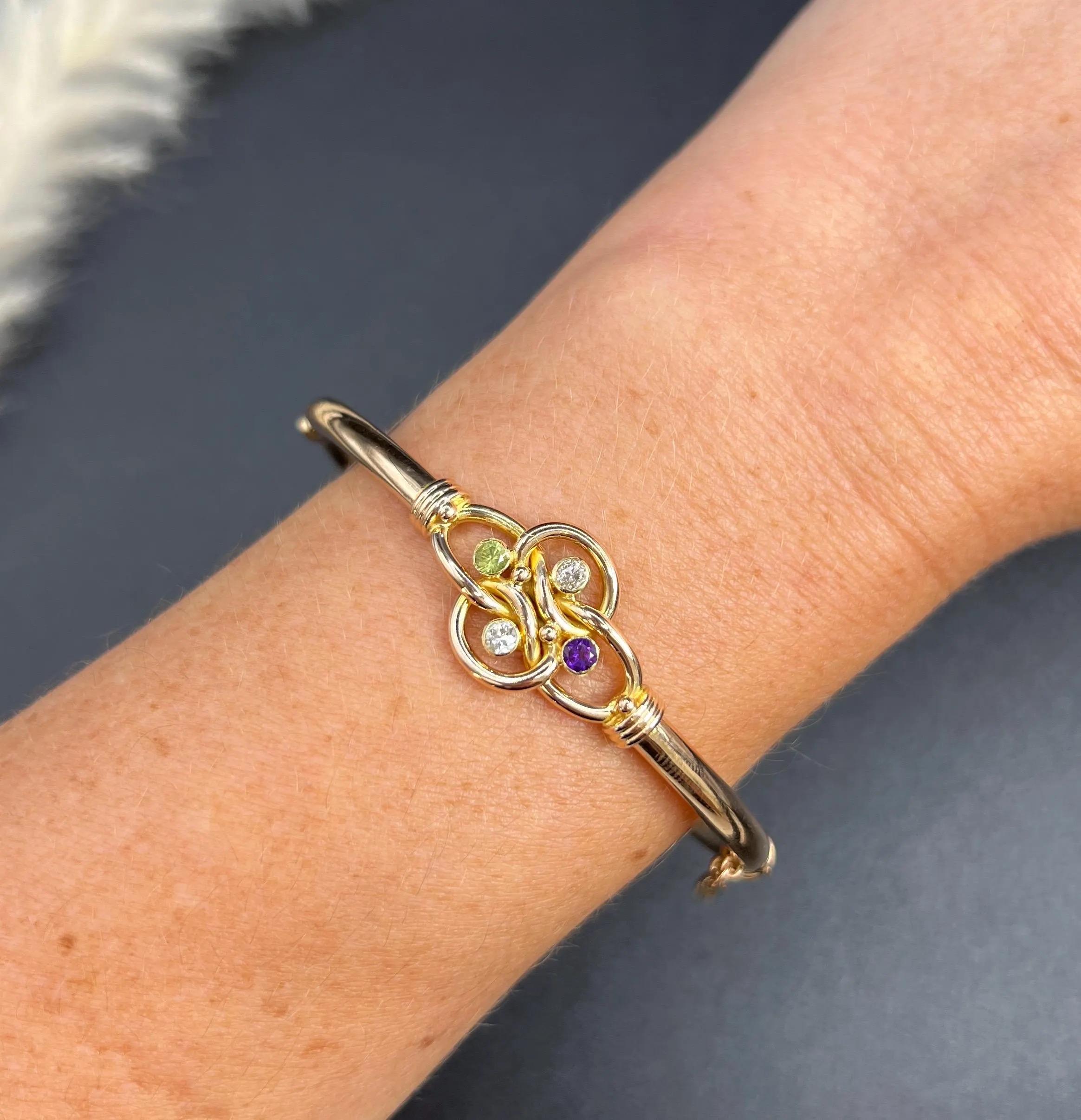 Antique Suffragette Bangle

15ct Yellow Gold

Circa 1910

Step back in time with this elegant 15ct yellow gold Edwardian era Suffragette bangle. This fabulous bracelet features a fancy knot focal point set with natural amethyst, peridot, and diamond