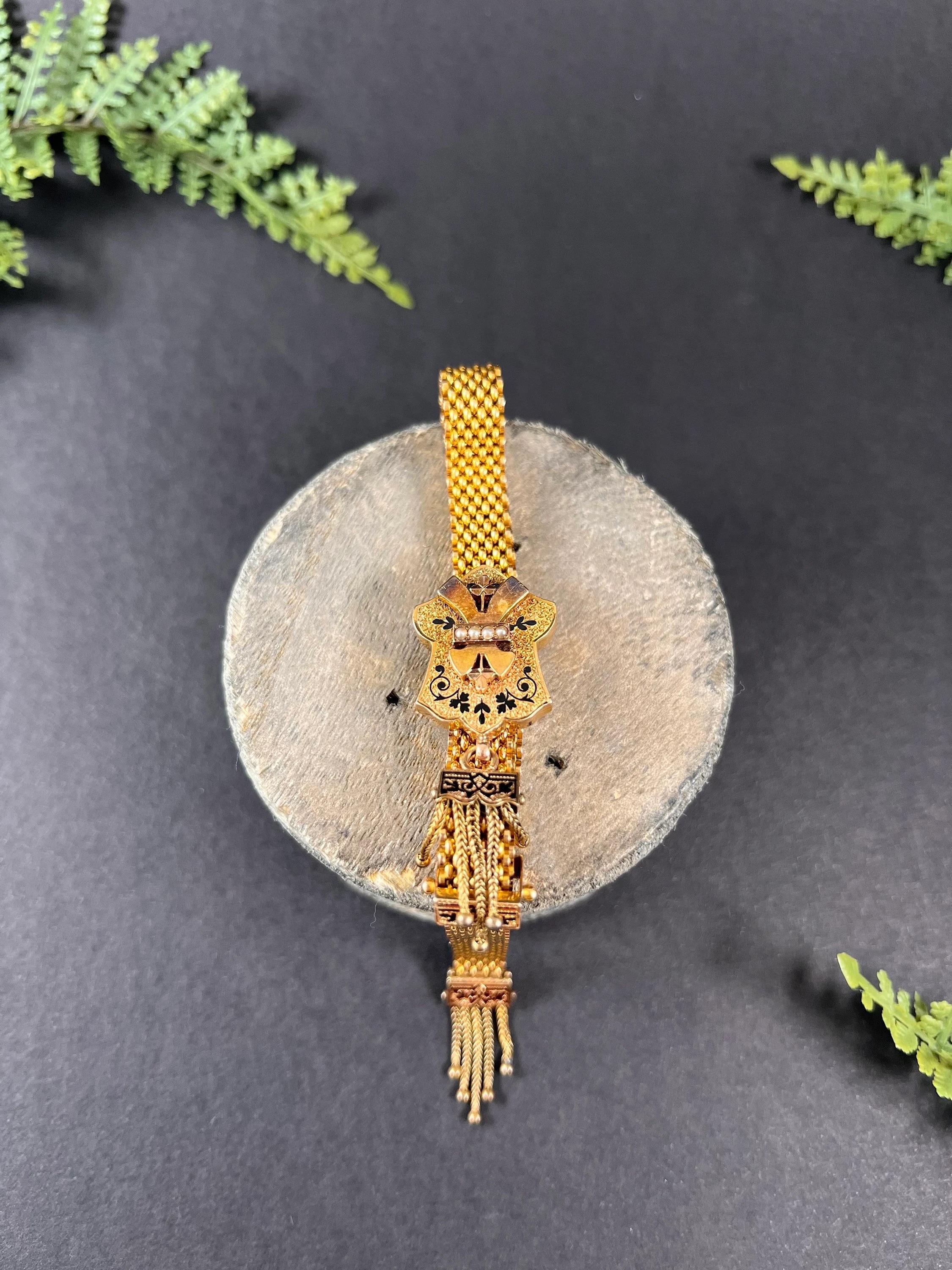 
Antique 15ct Yellow Gold and Enamel, Victorian Mesh Slide Bracelet with Gold Ball Tassels and Seed Pearls

15ct Yellow Gold Tested 

Circa 1880

This Victorian bracelet is a true masterpiece. Crafted with 15ct yellow gold, the mesh links wrap