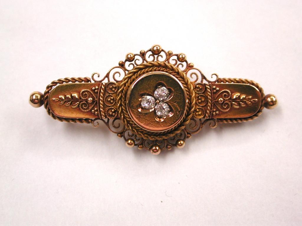 15ct Gold Hallmarked Etruscian Brooch set with Old Cut Diamonds,Birmingham 1897
Pretty etruscian work with filagree and 3 diamonds in a clover formation.
This brooch is in very good condition and made out of a heavy gauge of 15ct gold.
