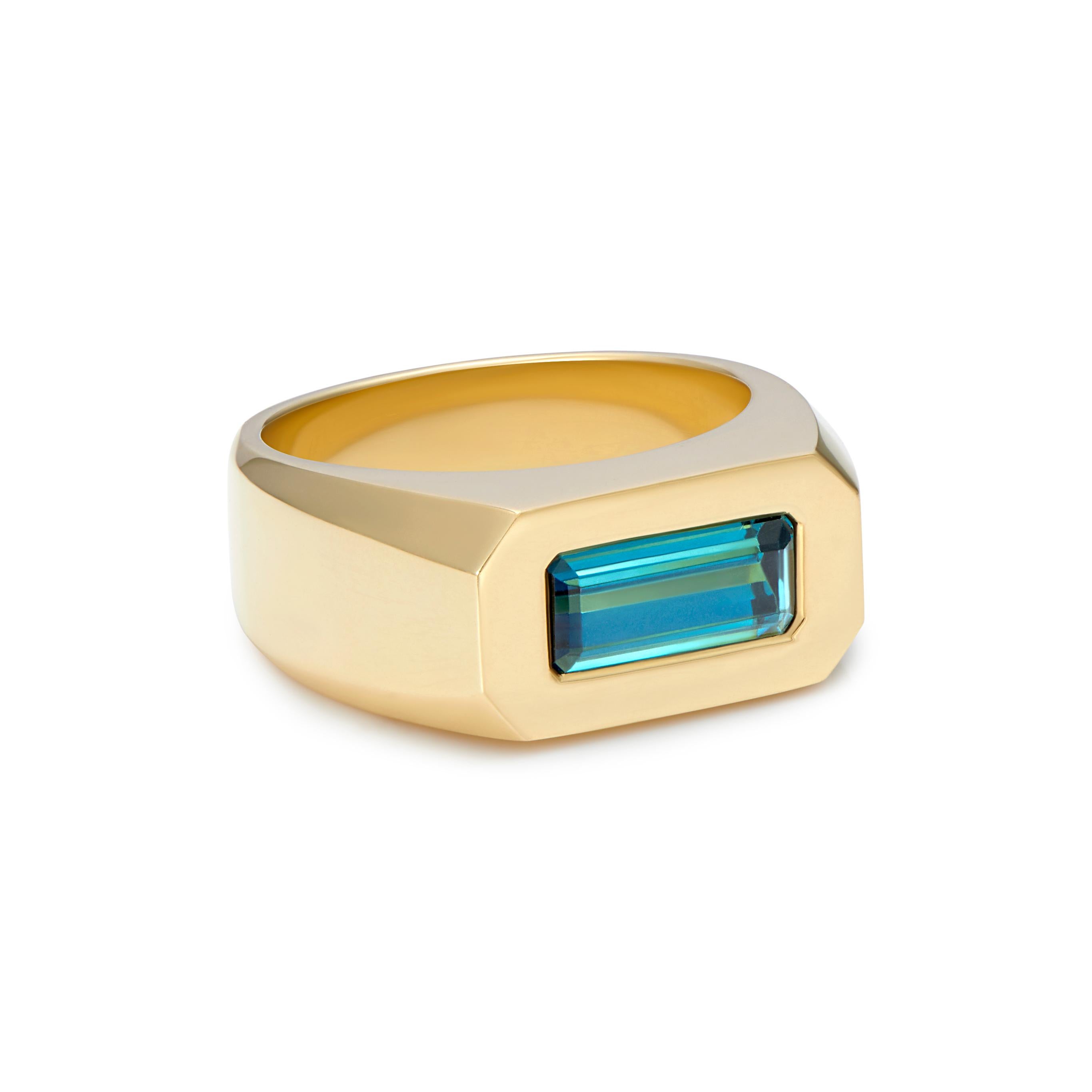 A beautiful 1.5ct teal Tourmaline ring set in 18kt yellow gold, hand made in England by exceptionally talented goldsmiths. This ring is set with a baguette-cut teal Tourmaline.

This collection distils the beauty and glamour of 1920s Berlin into a