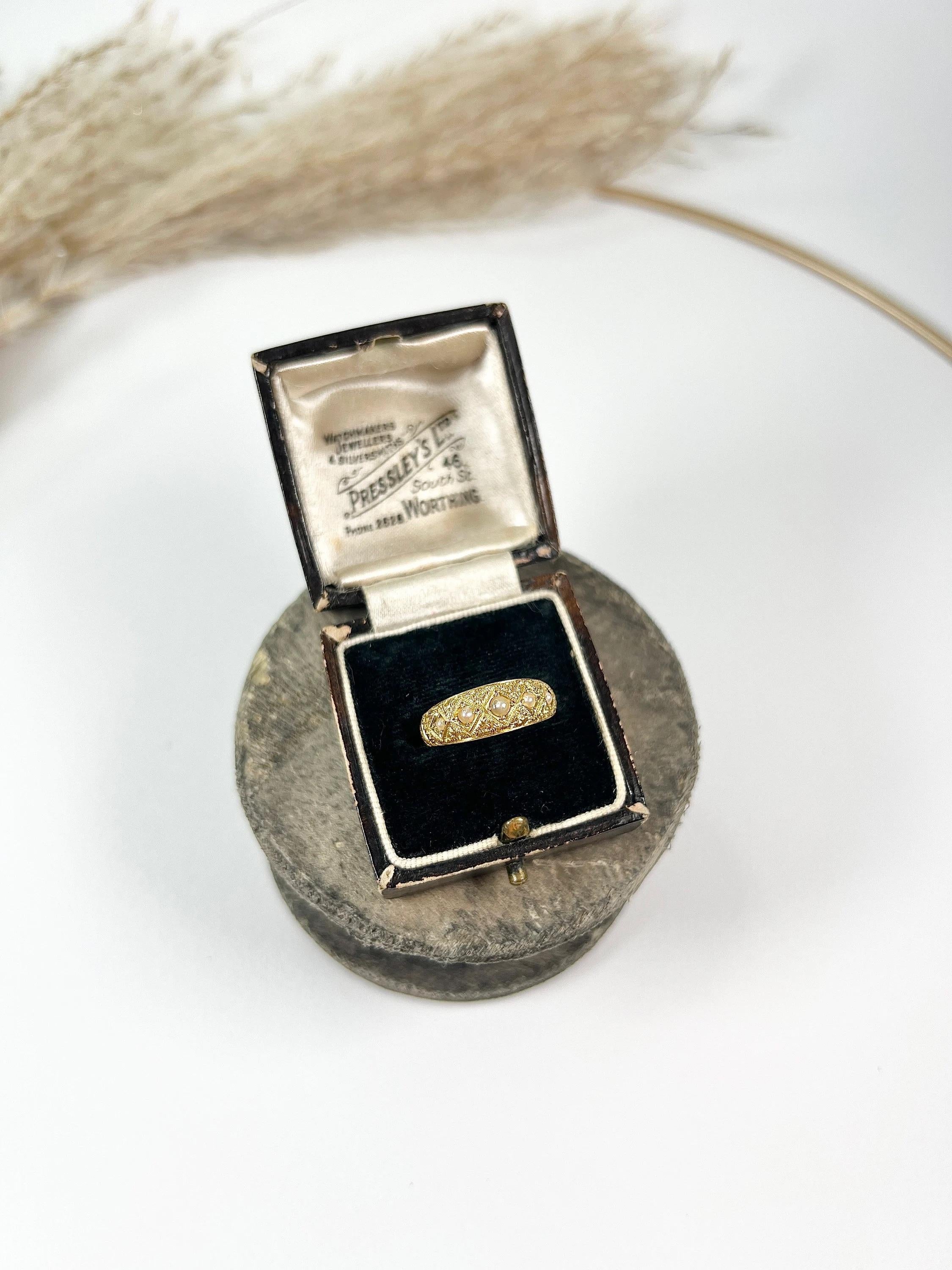 Antique Band Ring 

15ct Gold Stamped 

Hallmarked Chester 1887

This exquisite Victorian Band ring is crafted from 15ct gold and showcases five natural seed pearls. The intricate hand-carved gold work adds a touch of elegance and charm to this