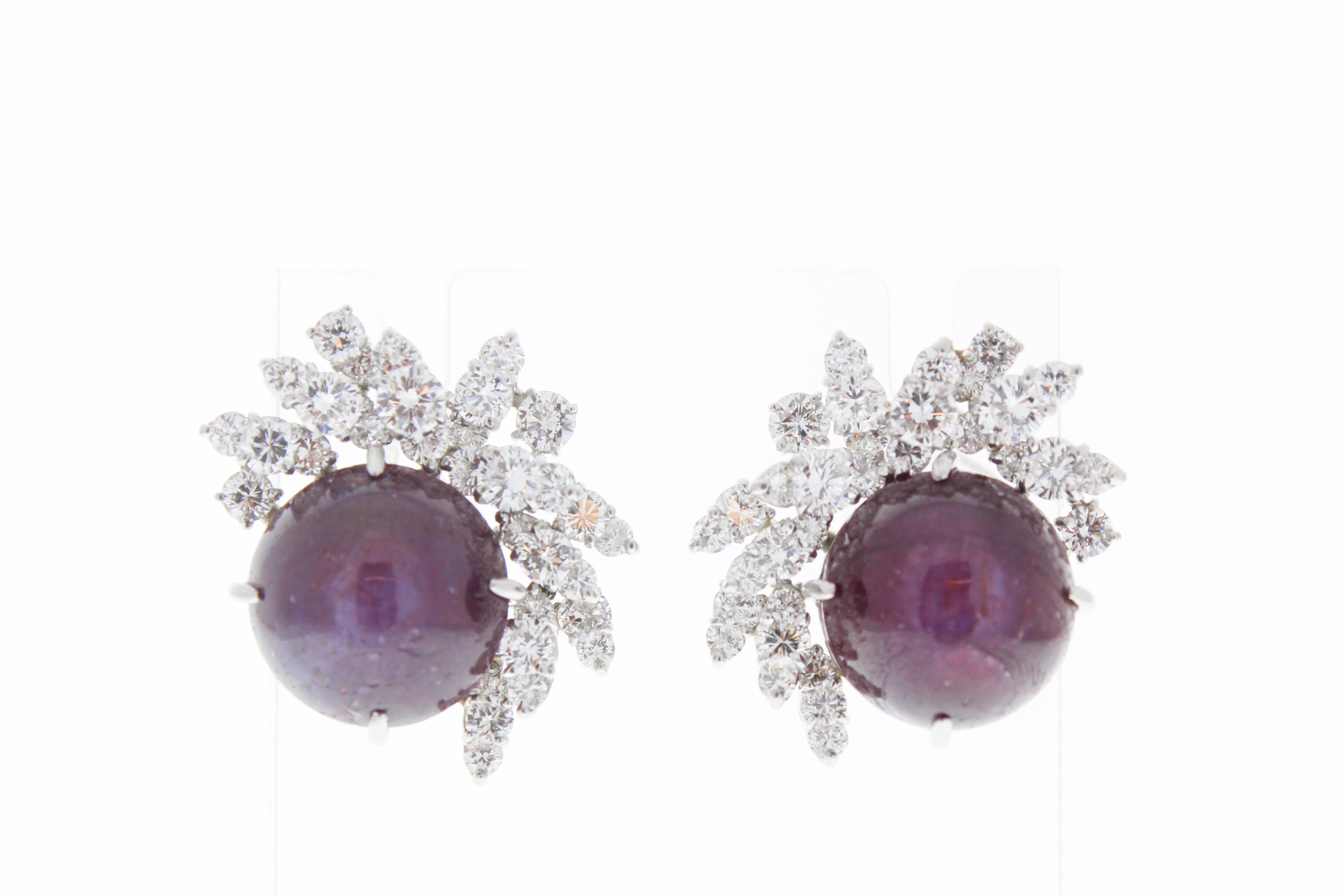 These unique earrings consist of two ruby cabochons that total up to 15carats. There are 64 diamonds that total up to 4.40carats.  The earrings are set in platinum.