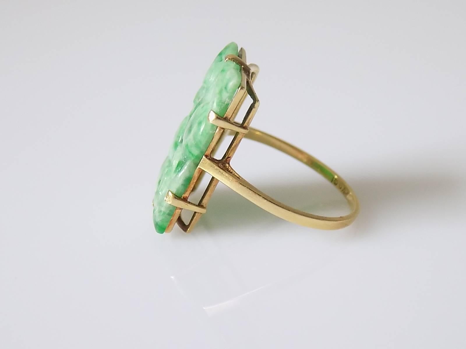 A Beautiful Art Deco c.1920s 15 Carat Gold and Carved jadeite jade ring. English origin.
Size N UK, 7 US,
Height of the face including claws 20mm, Width 14mm.
Weight 3.1gr.
Marked 15CT for 15 Carat Gold.