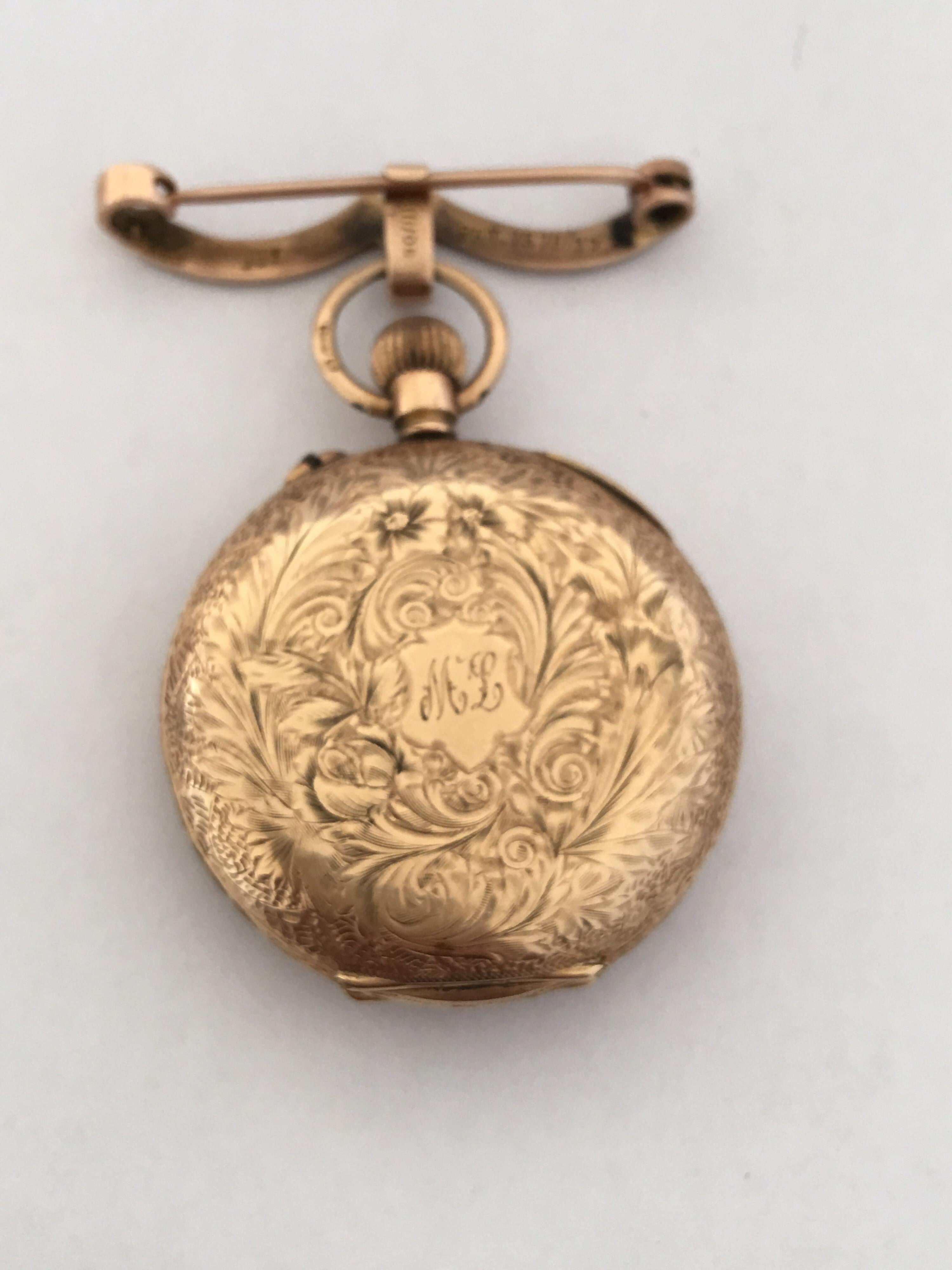 This beautifully gold engraved case and creatively inlaid gold and enamel dial brooch fob watch is in good working condition. Visible worn dents on the side of the case watch.