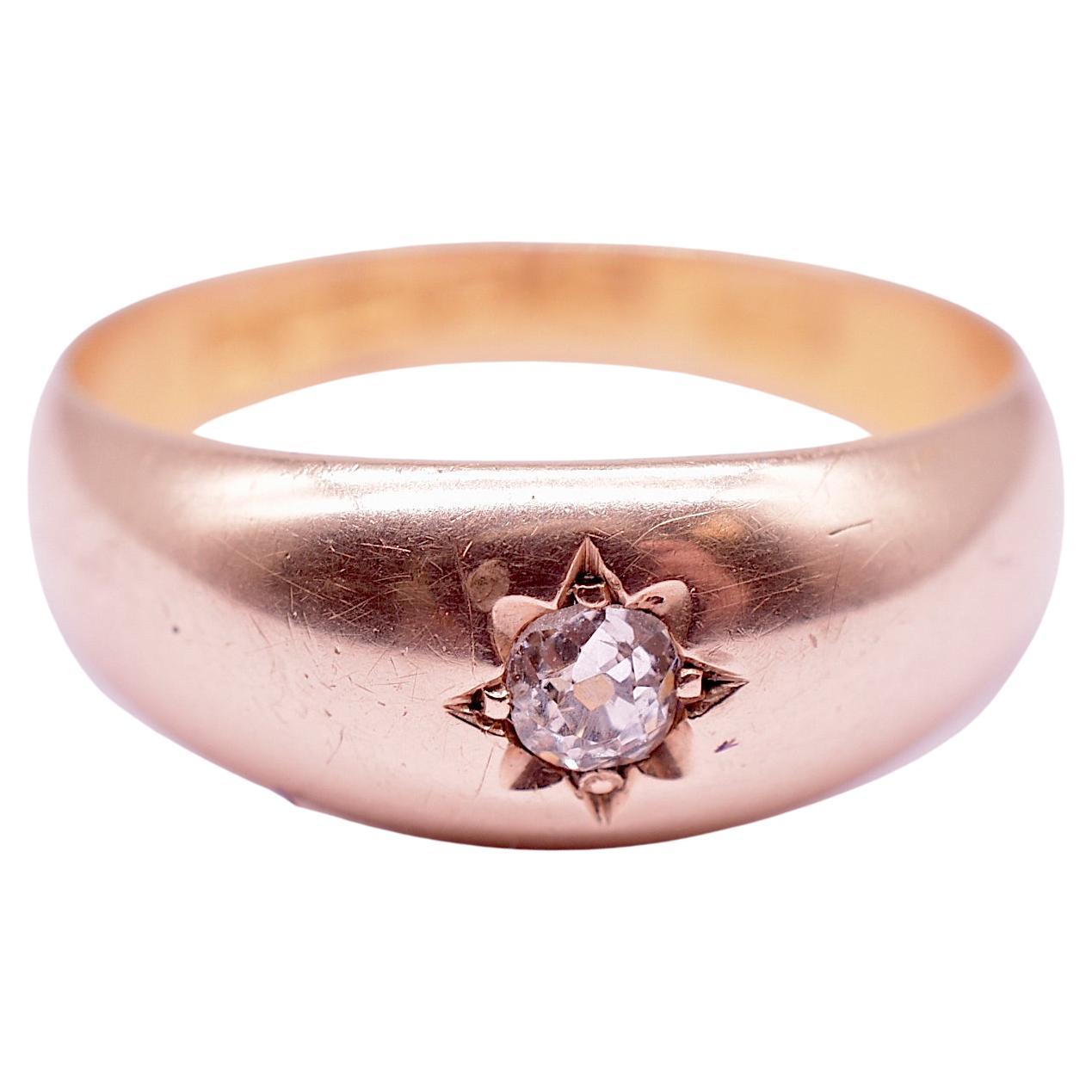 Charming 15K Victorian surface mount ring with a single old mine cut diamond securely imbedded in a polished gold band. The ring is hallmarked for Chester 1890. This type of setting was popular through the late 19th century and well into the 20th.