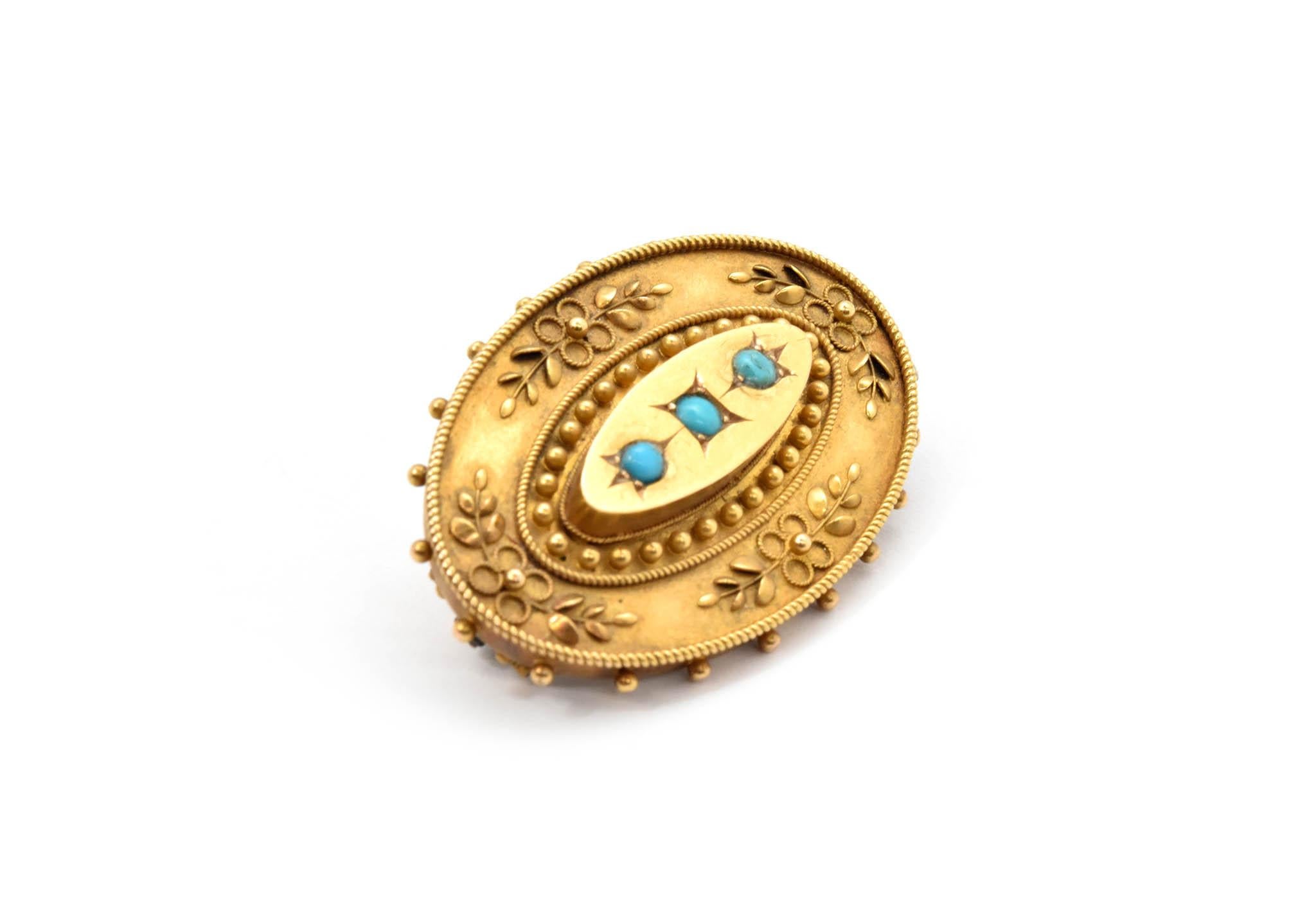 This 15k yellow gold pin is set with 3 small turquoise beads. Each bead measures about 3mm in diameter. The pin measures 25x40mm and weighs 10.2 grams. The back of the pin is stamped “15ct.” 