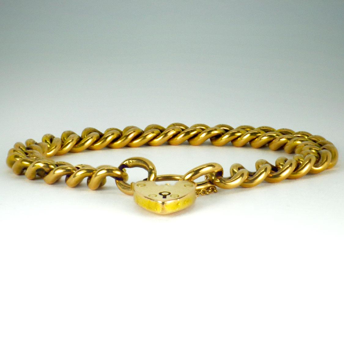 A 15 karat (15K) yellow gold bracelet designed as a curb link chain with padlock heart closure and safety chain. Each link stamped ‘15’ for 15 karat gold, the padlock stamped 15ct with maker’s mark B&S. 8.5” long.

Dimensions: 21.75 x 0.9 cm
Weight: