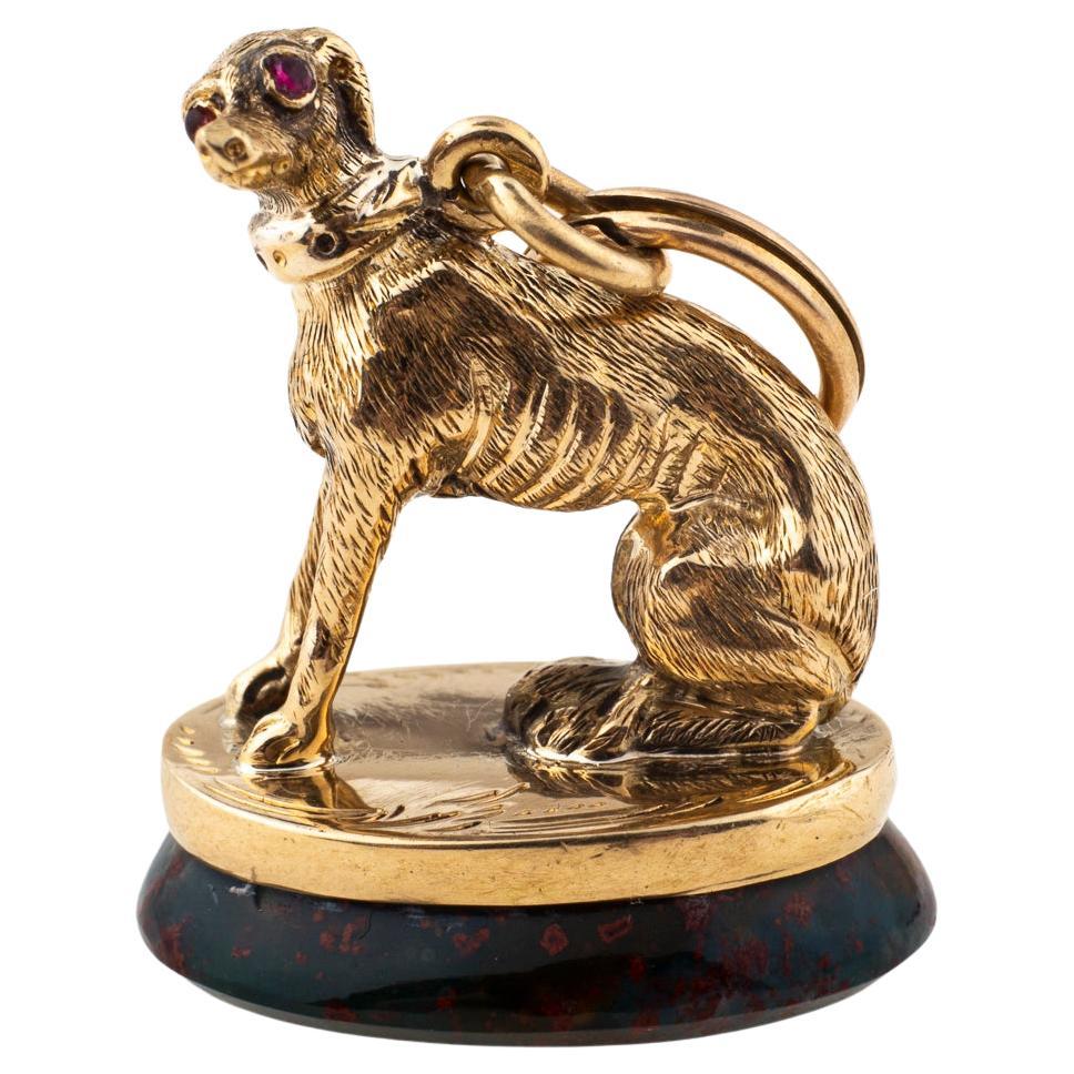Slender like the beautiful dog it represents this Italian Greyhound Fob is 15 Kt gold with a gleaming eye and bloodstone base. Its slim body shows its delicate skeletal structure. Made in 1850 of English origin. 1 inch in length